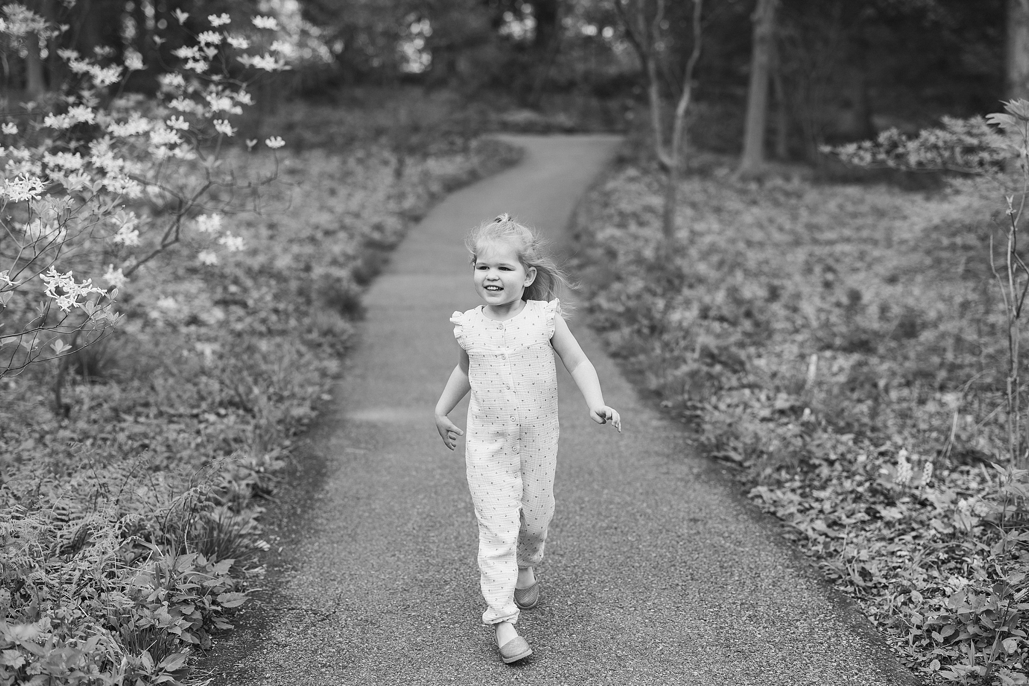 toddler walks down path in gardens at Longwood Gardens 