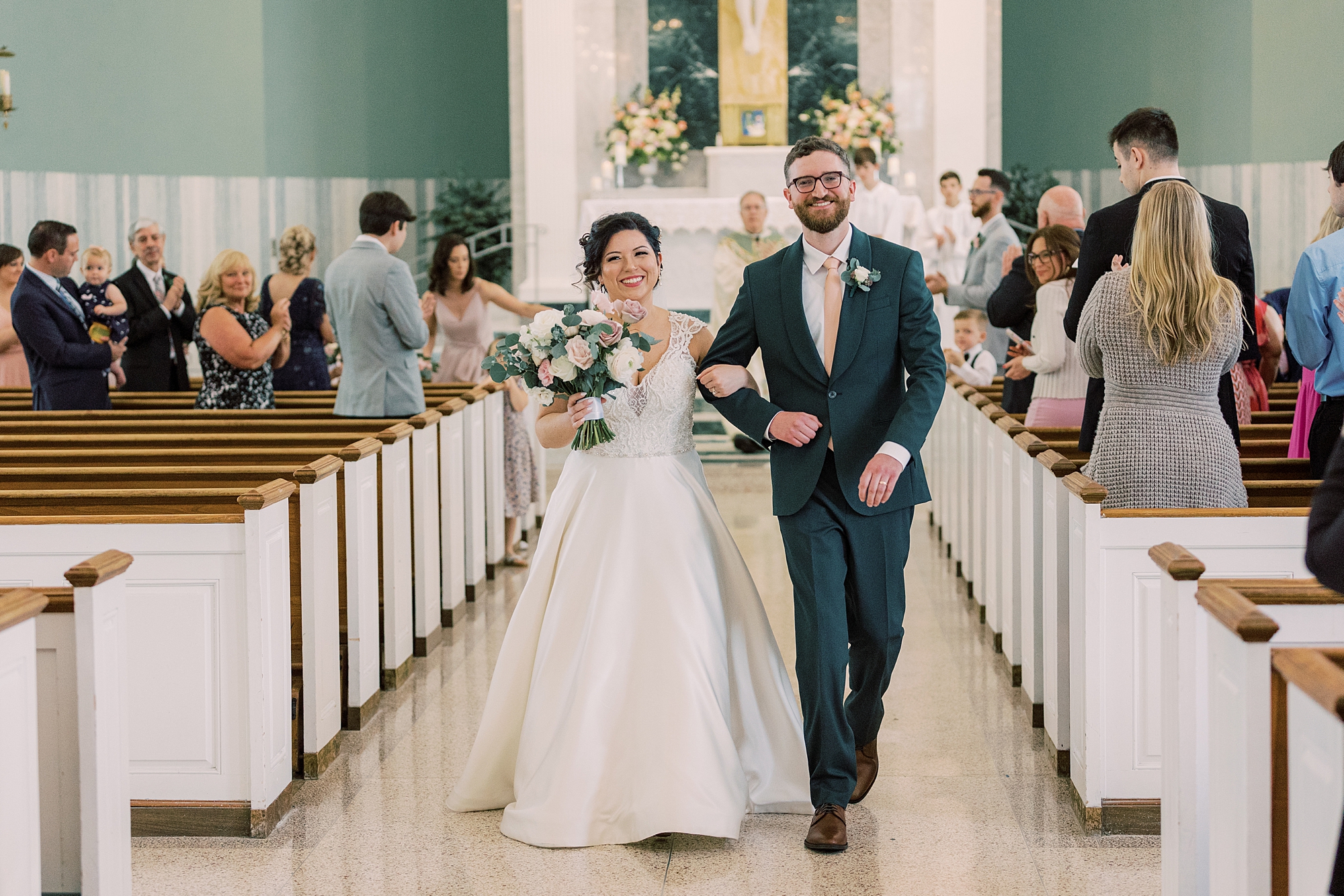 bride and groom walk up aisle after wedding ceremony at St. Dorothy's in Drexel Hall