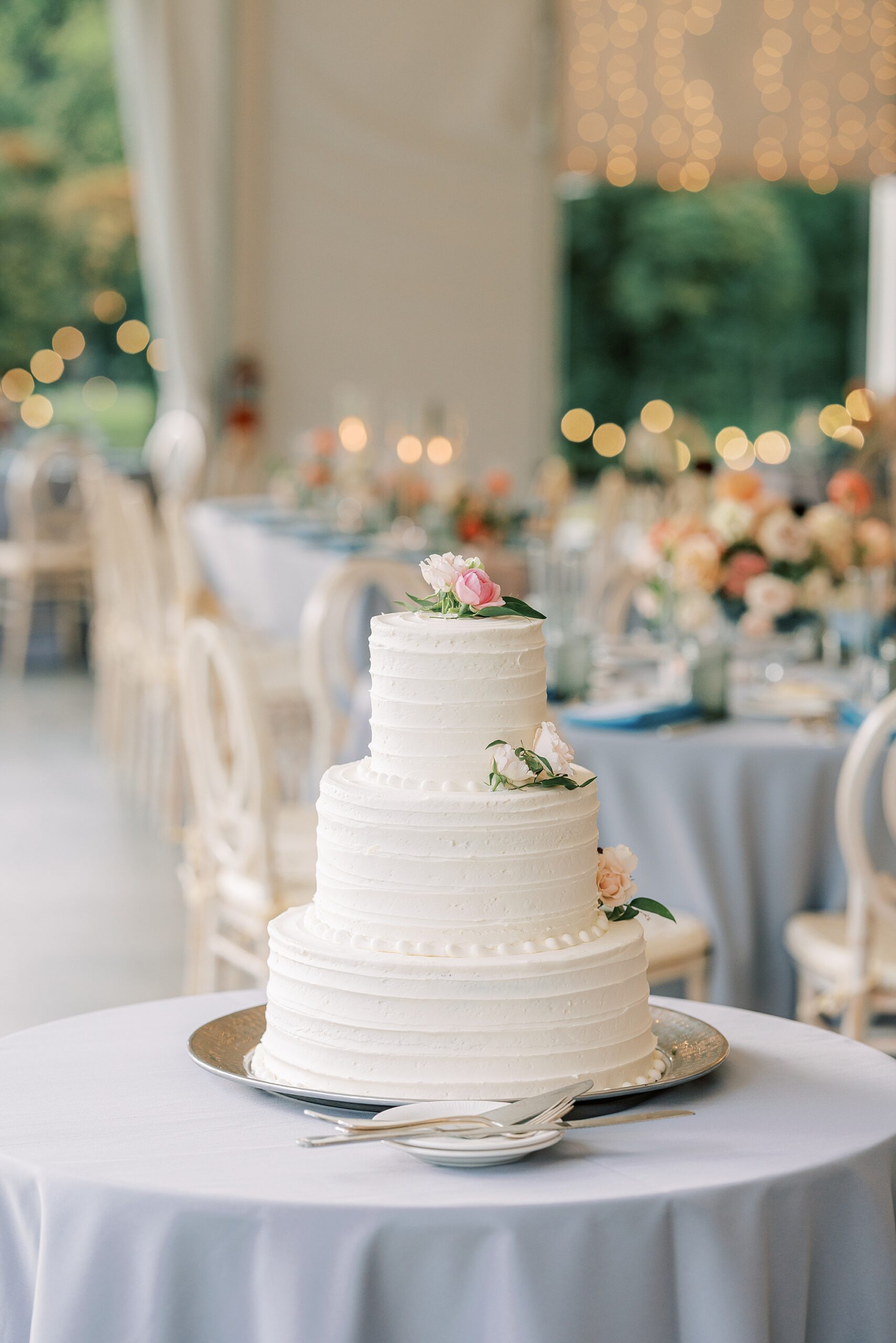 tiered wedding cake with flowers on top at Bellevue Hall