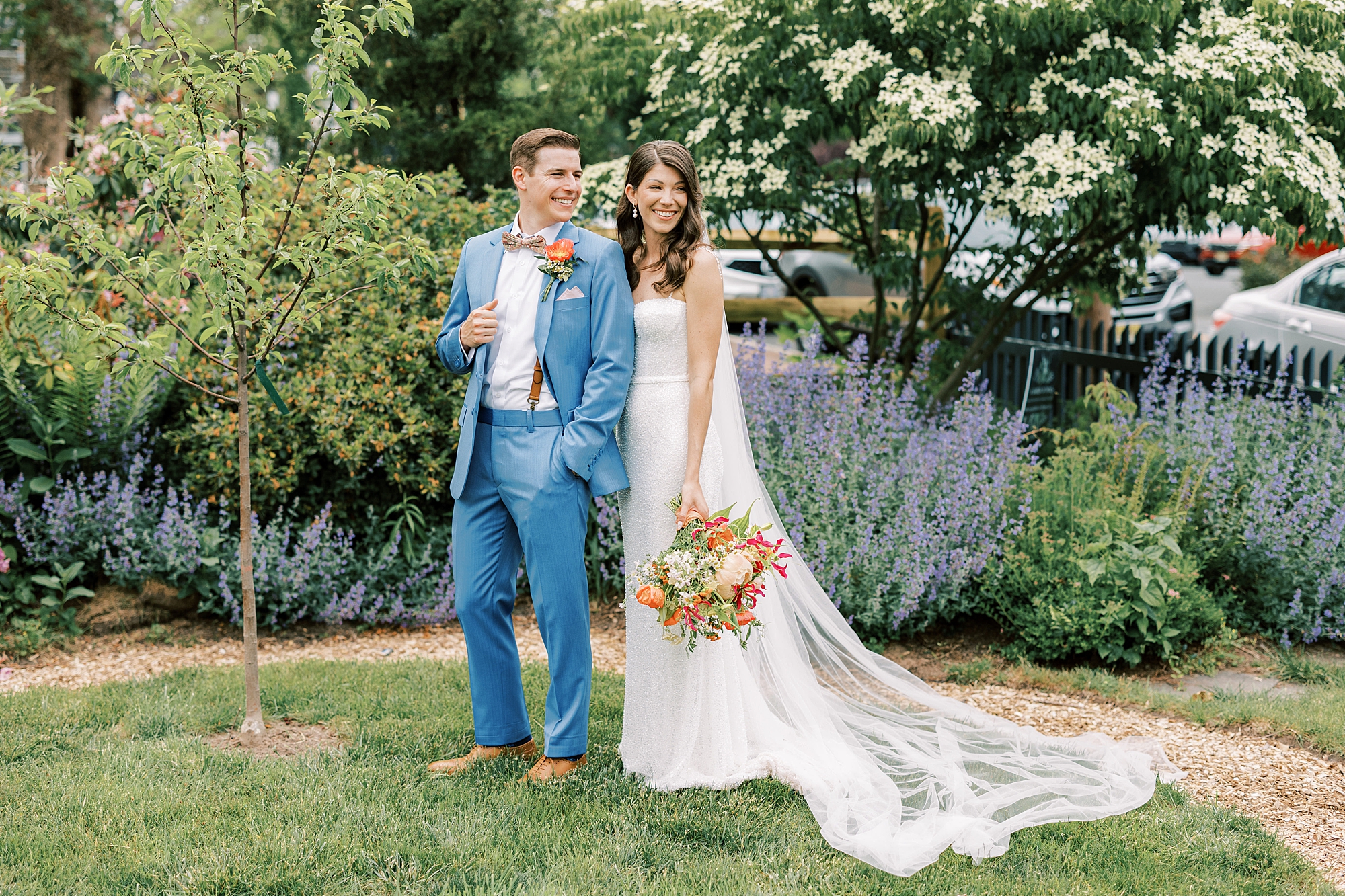 bride and groom pose in garden with lavender in New Hope 