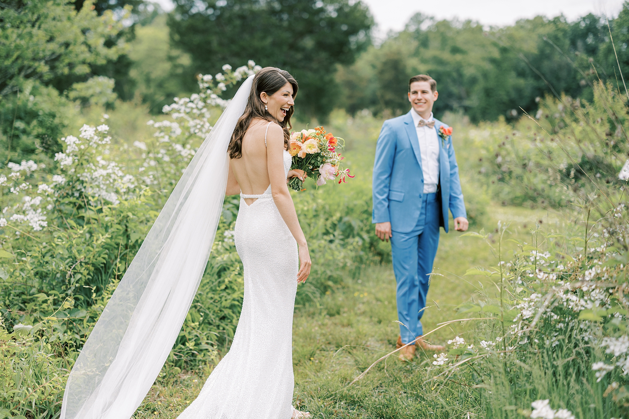 groom turns to look at bride in gardens at Bowman's Hill Wildflower Preserve wedding