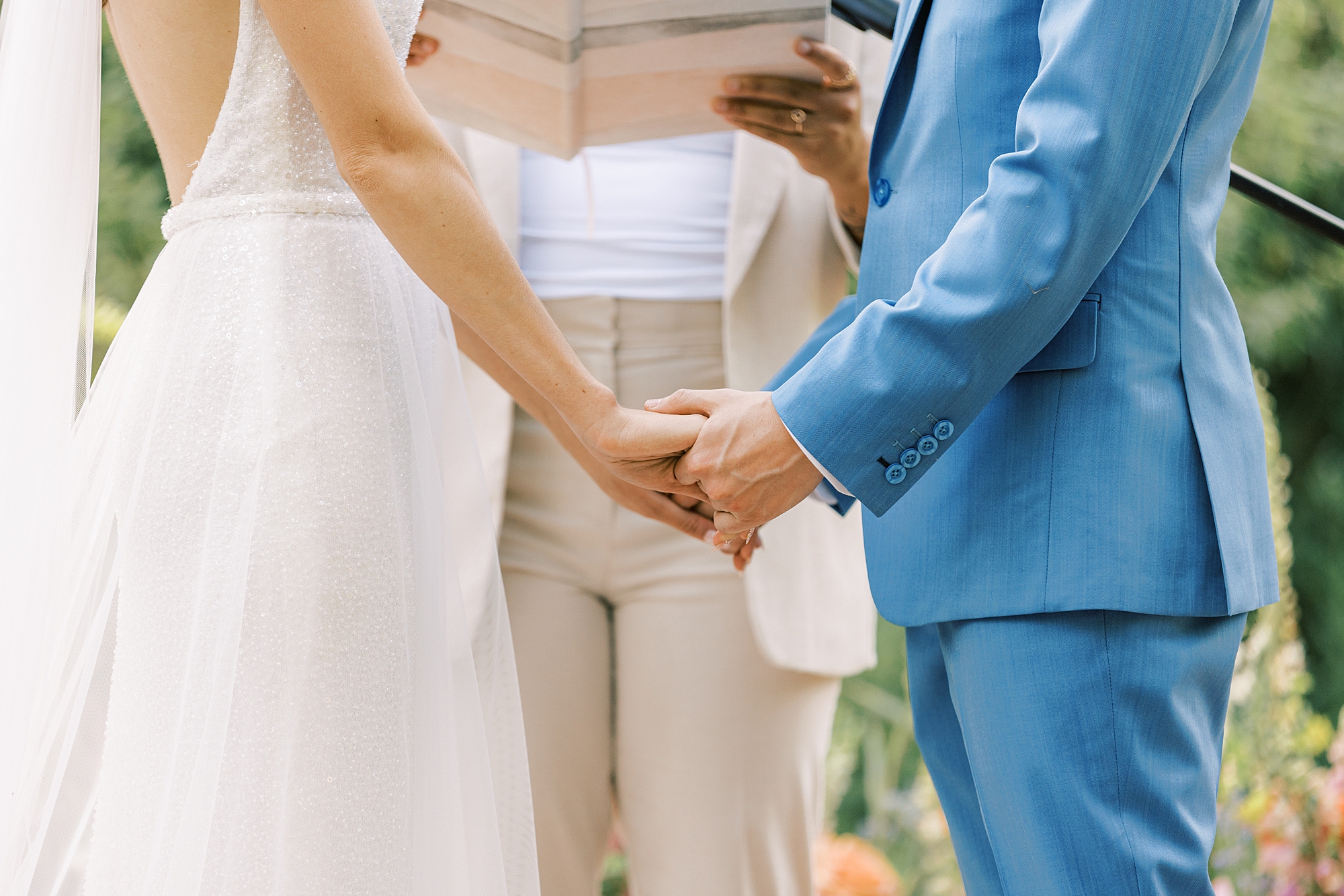 newlyweds hold hands during wedding ceremony in PA