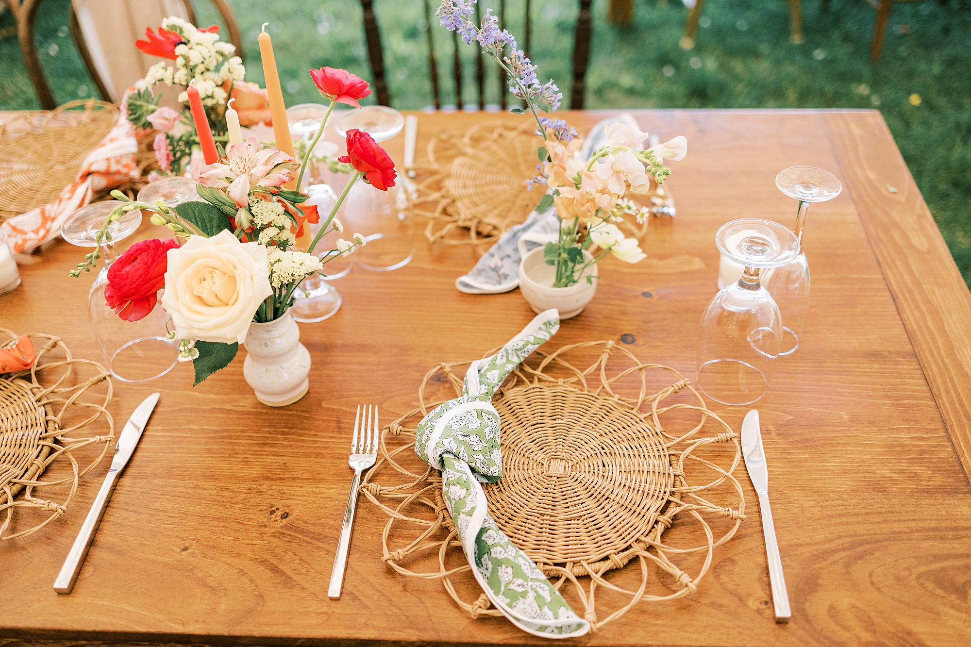 boho 70's inspired place setting with red and pink roses during reception at Bowman's Hill Wildflower Preserve