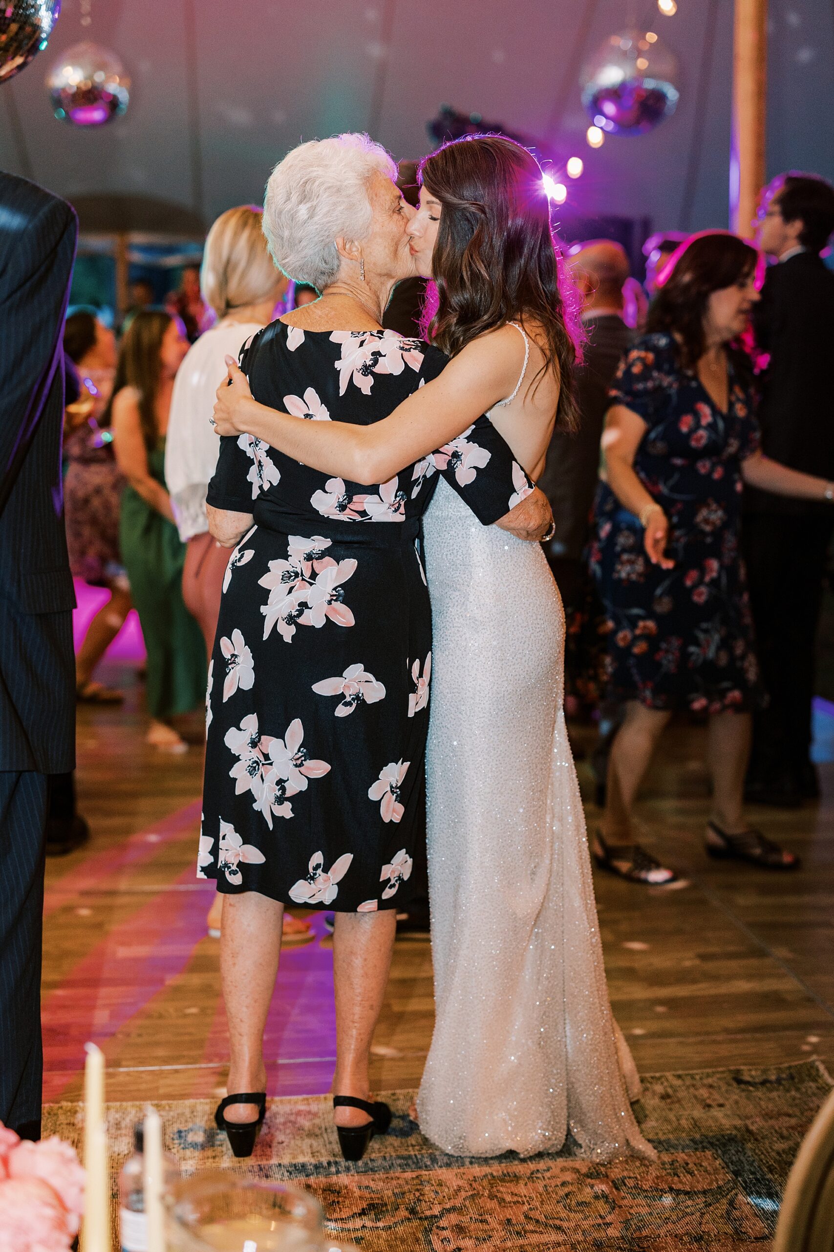 bride kisses grandmother during reception 