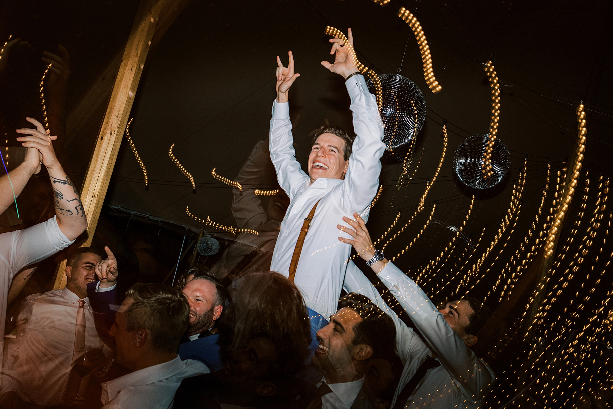guests lift up groom during silent disco at Bowman's Hill Wildflower Preserve