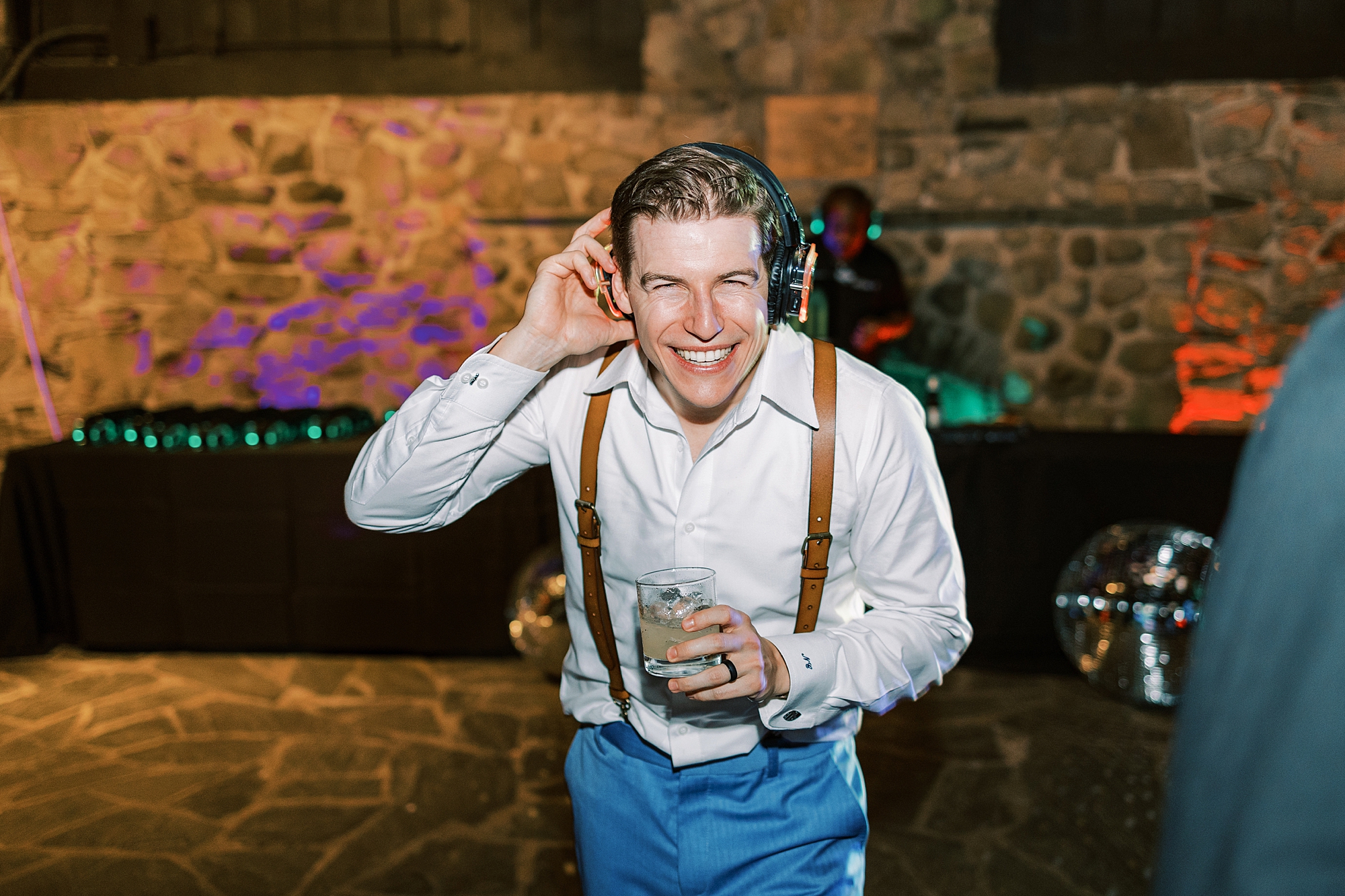 groom grins with headphones on during silent disco at Bowman's Hill Wildflower Preserve