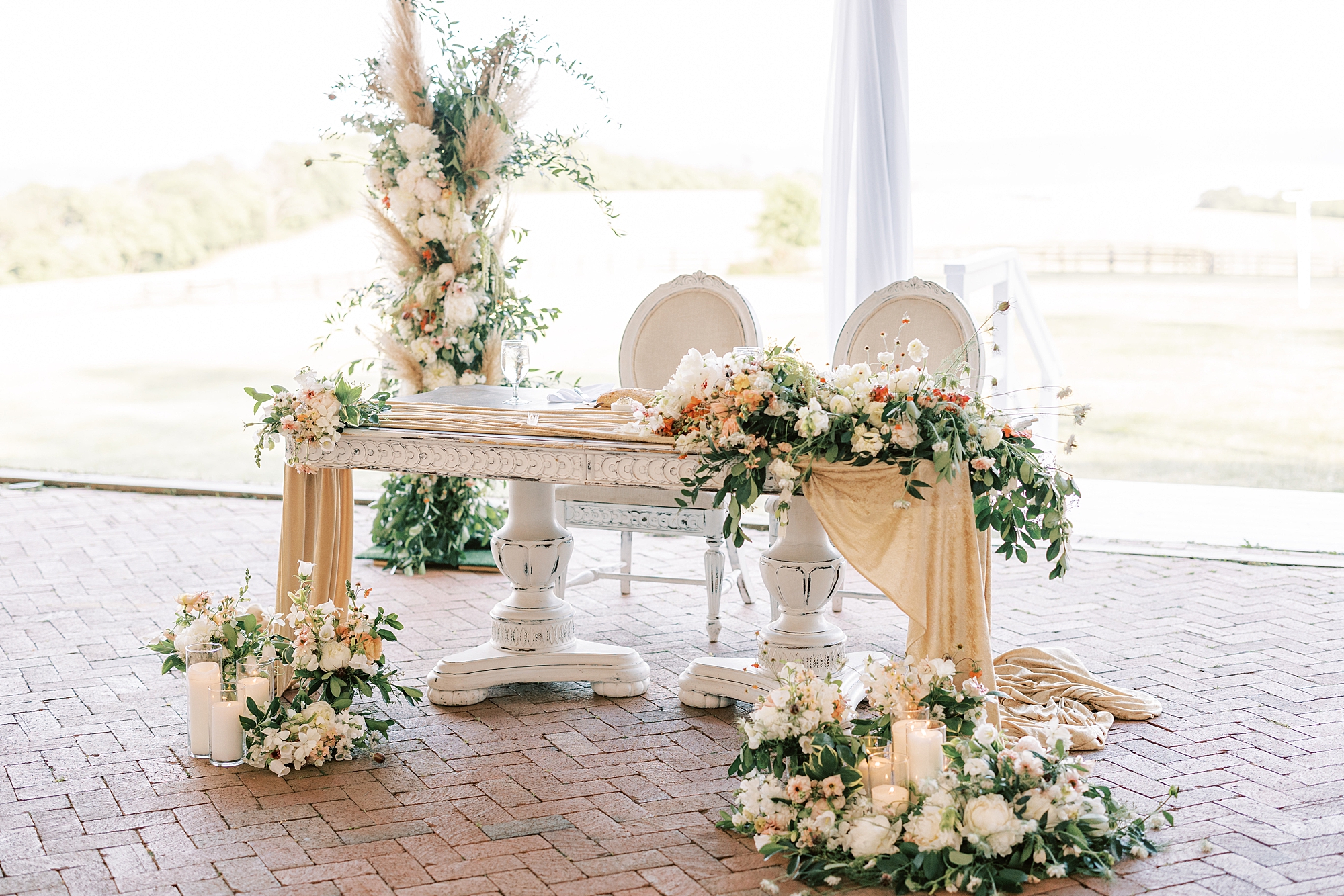 sweetheart table with overflowing white and pink flowers for wedding reception at Lauxmont Farms