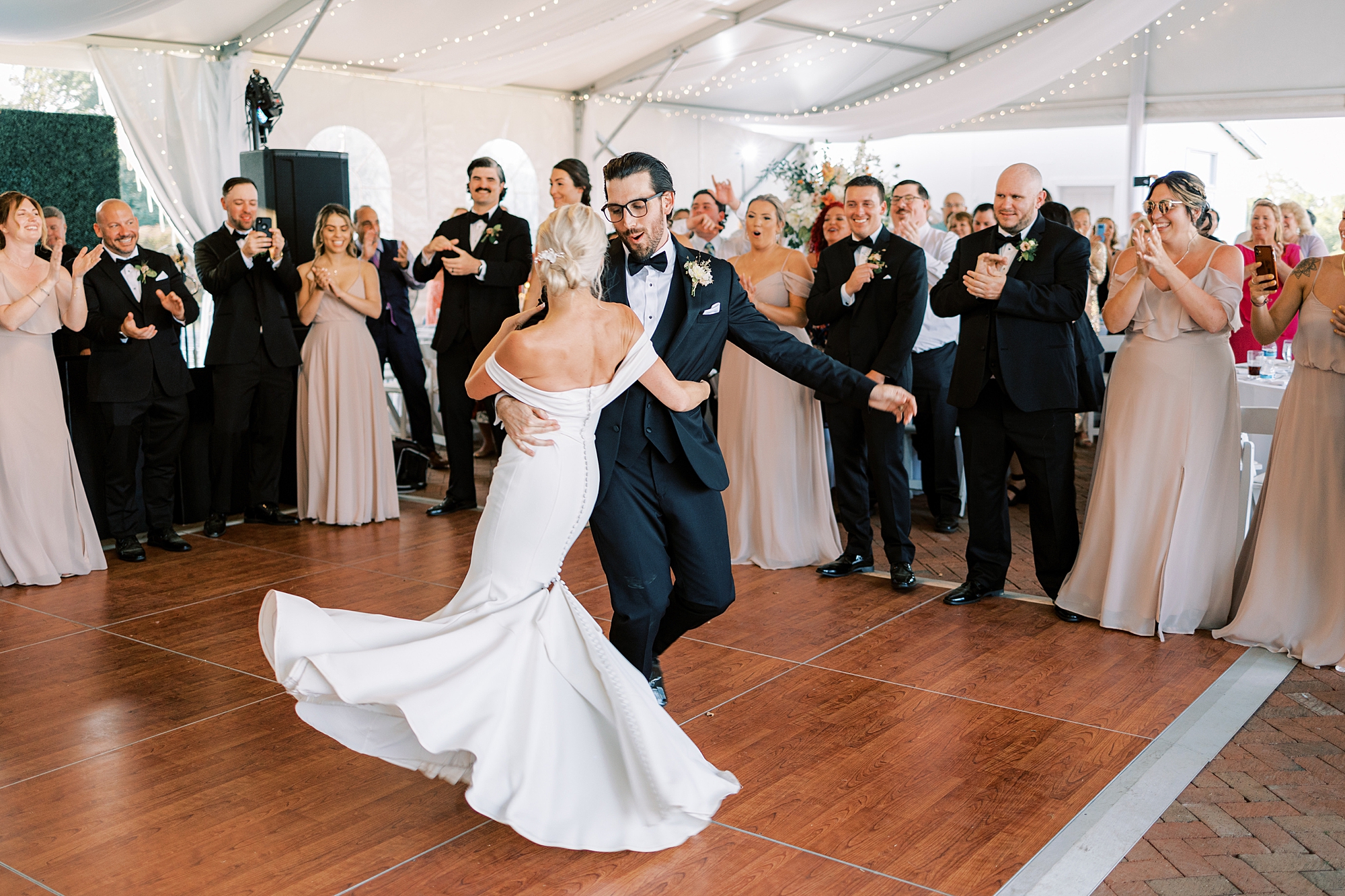 bride and groom dance on dance floor during wedding reception at Lauxmont Farms