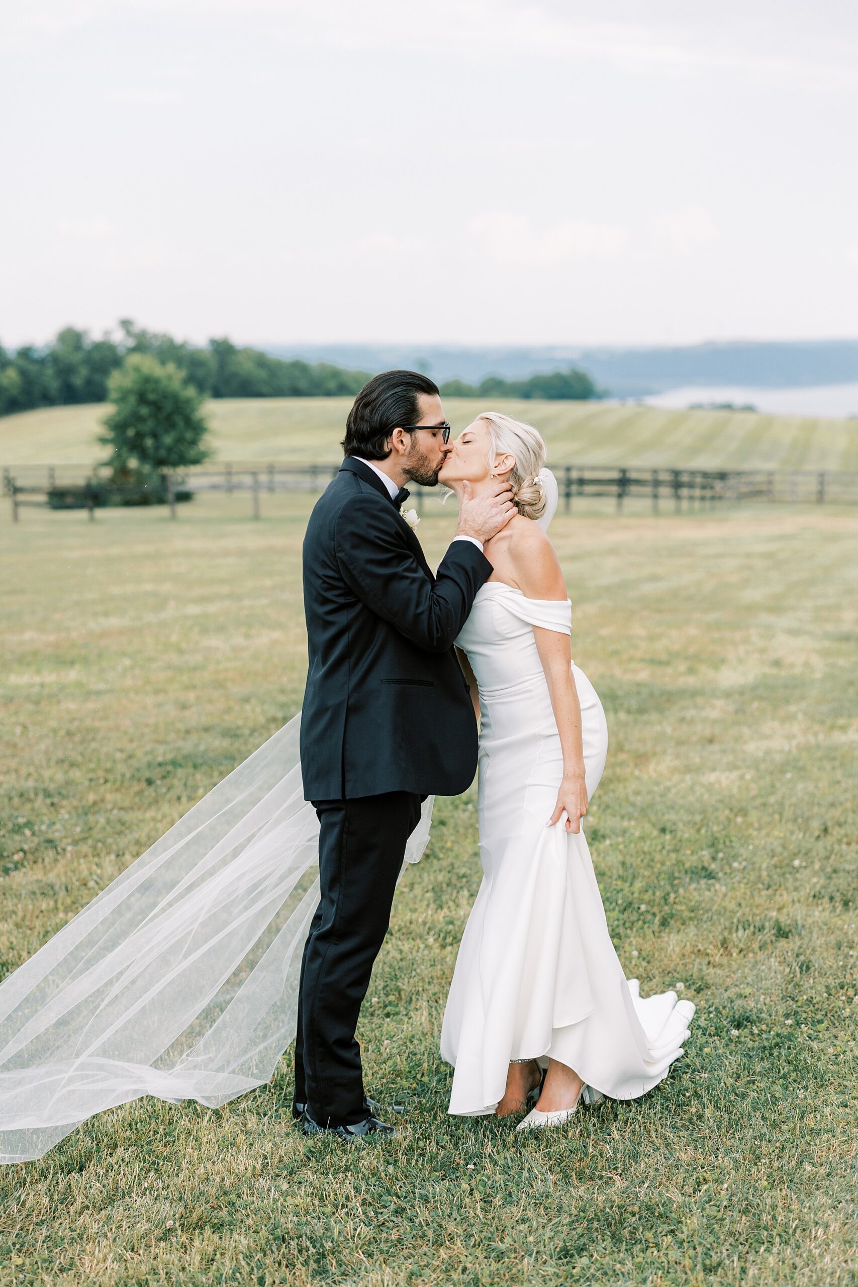 bride and groom kiss on lawn at Lauxmont Farms