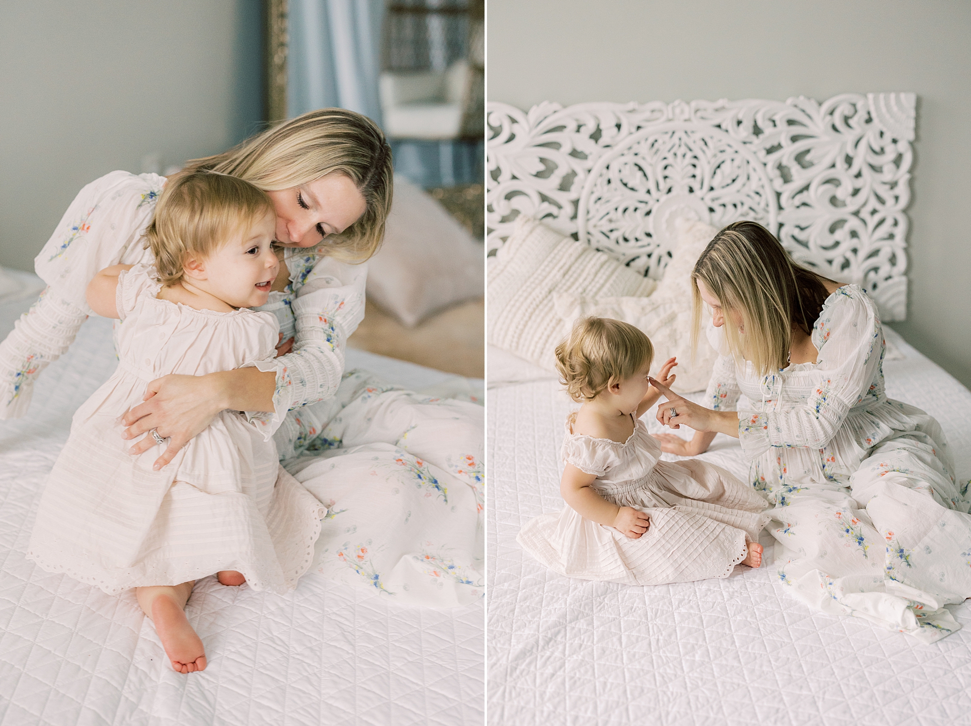 mom kisses and plays with toddler daughter on bed with white sheets