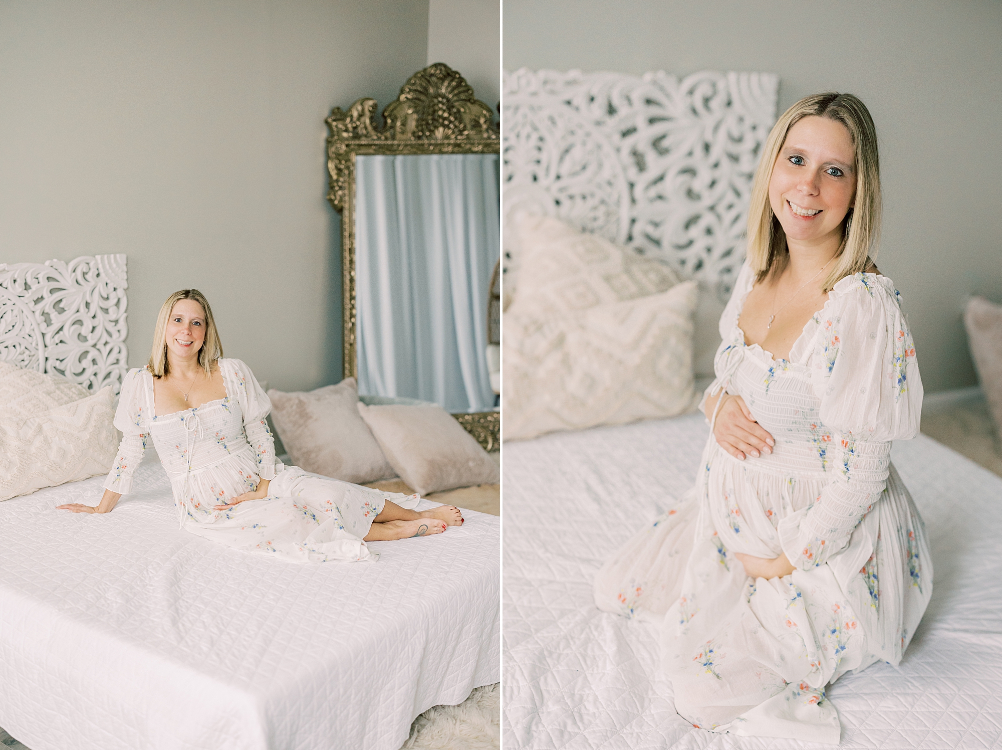 mom in white off-the-shoulder gown lays on bed holding baby bump during studio maternity session in Media PA
