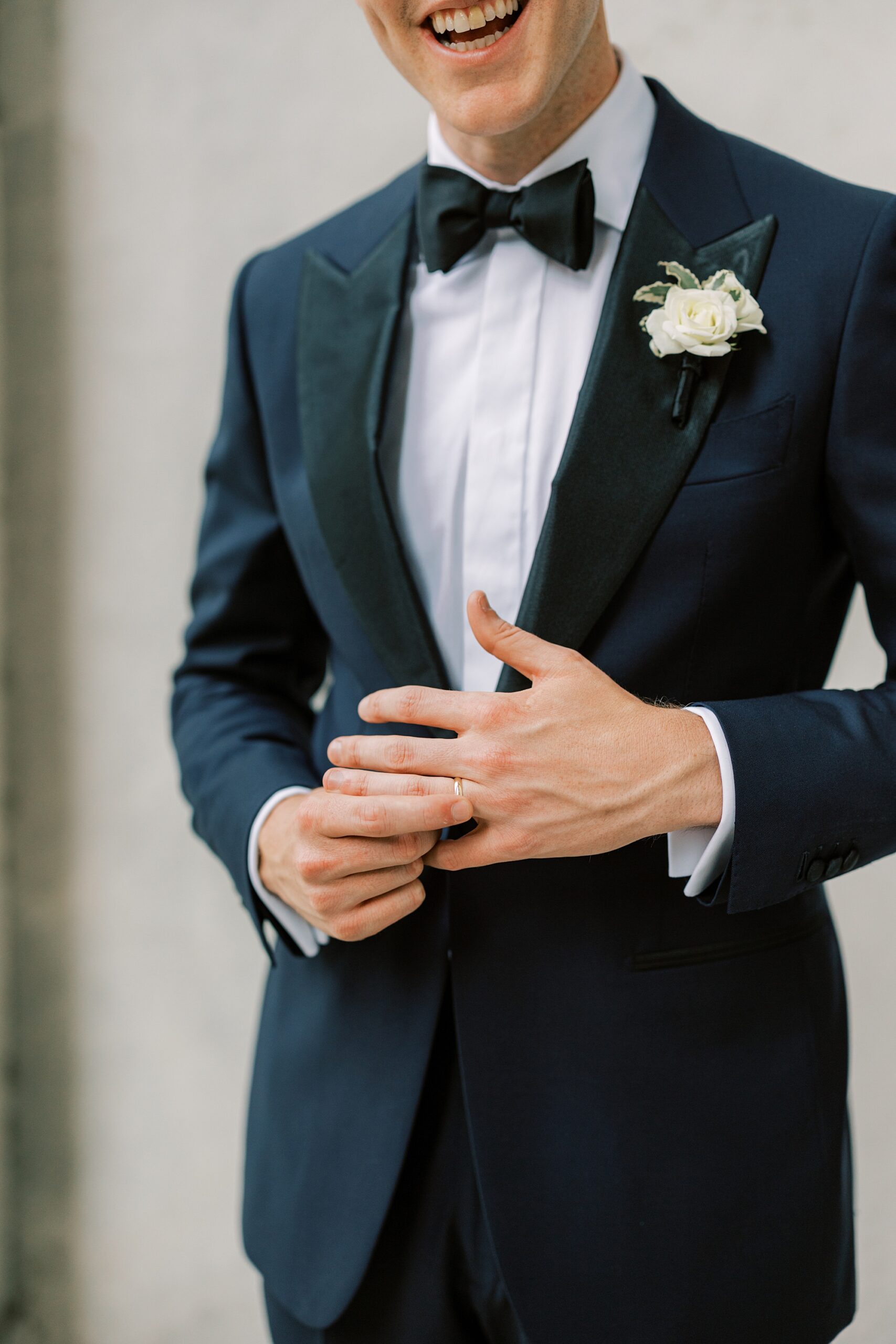 a detail of a groom fiddling with his new ring