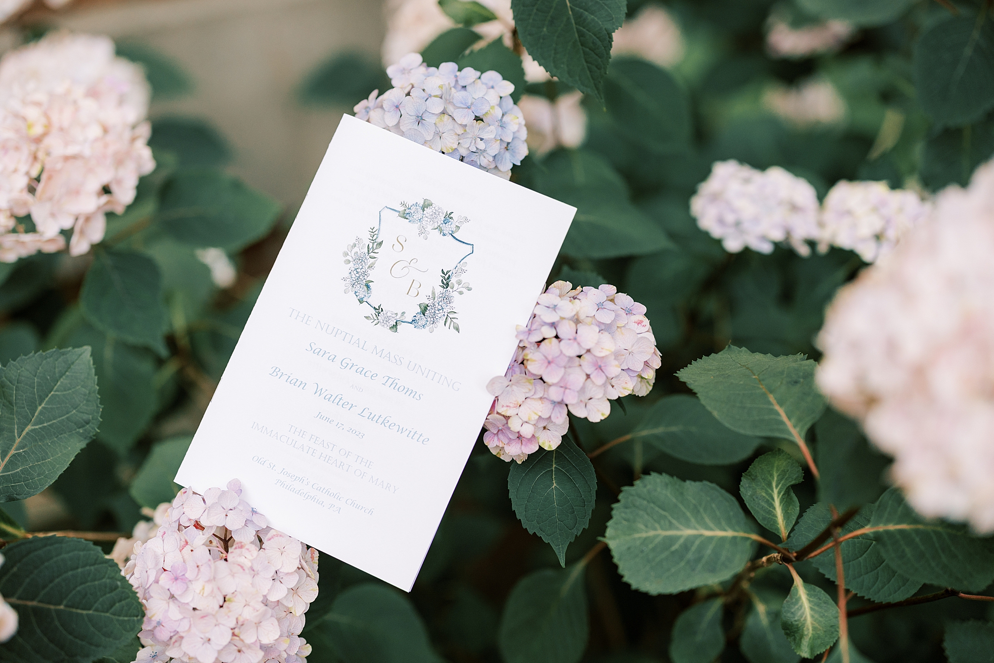 ceremony program rests on pink and purple hydrangeas in Philly 