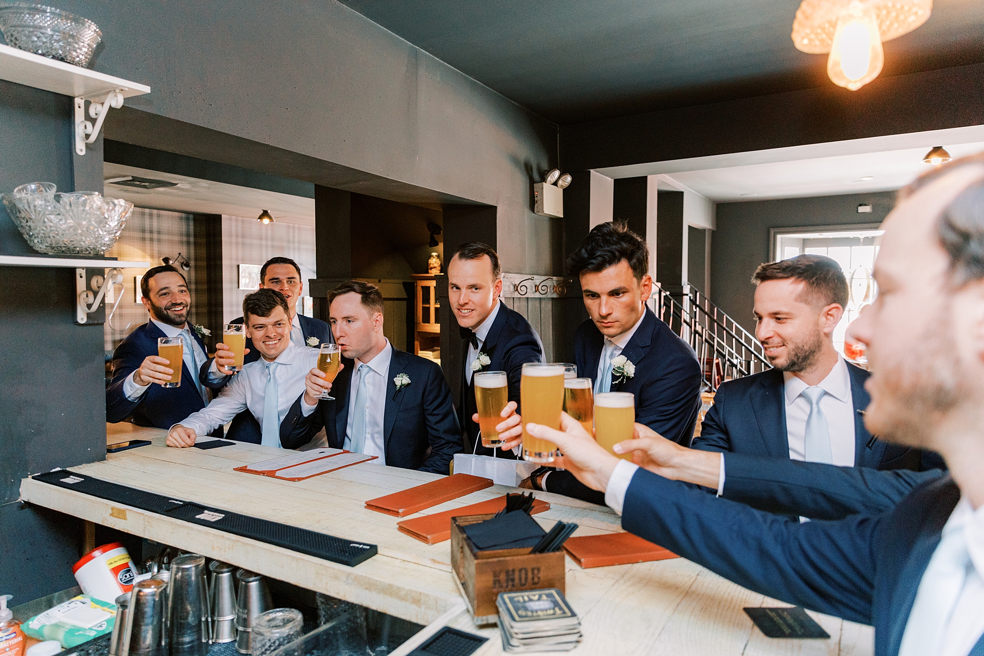 groom and groomsmen toast with beers before PA wedding