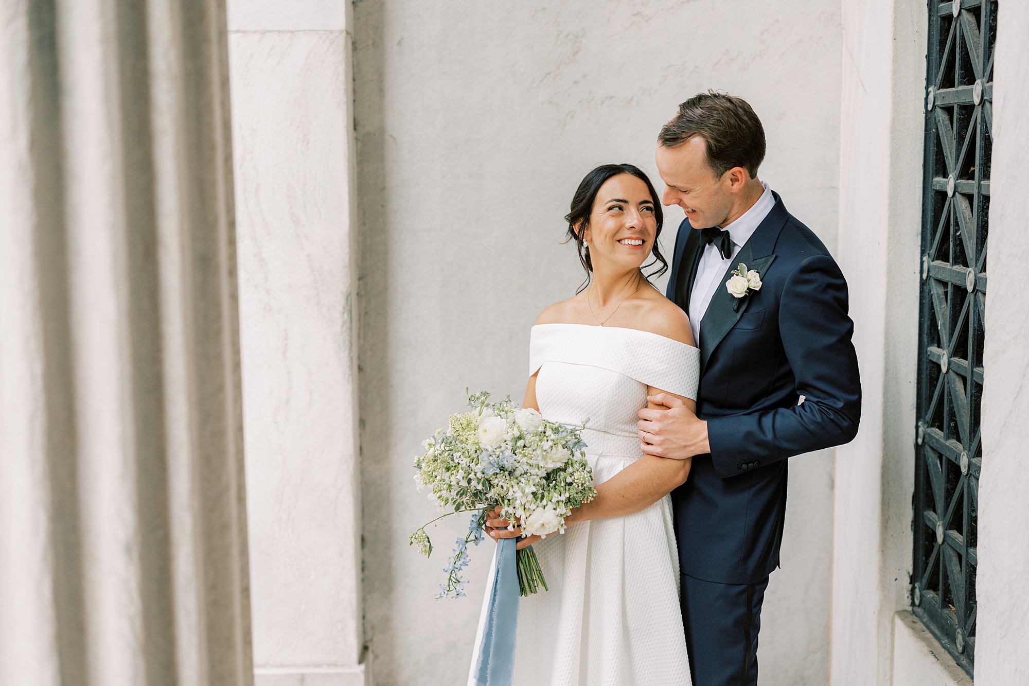 bride stares lovingly at her groom during Philadelphia portrait session