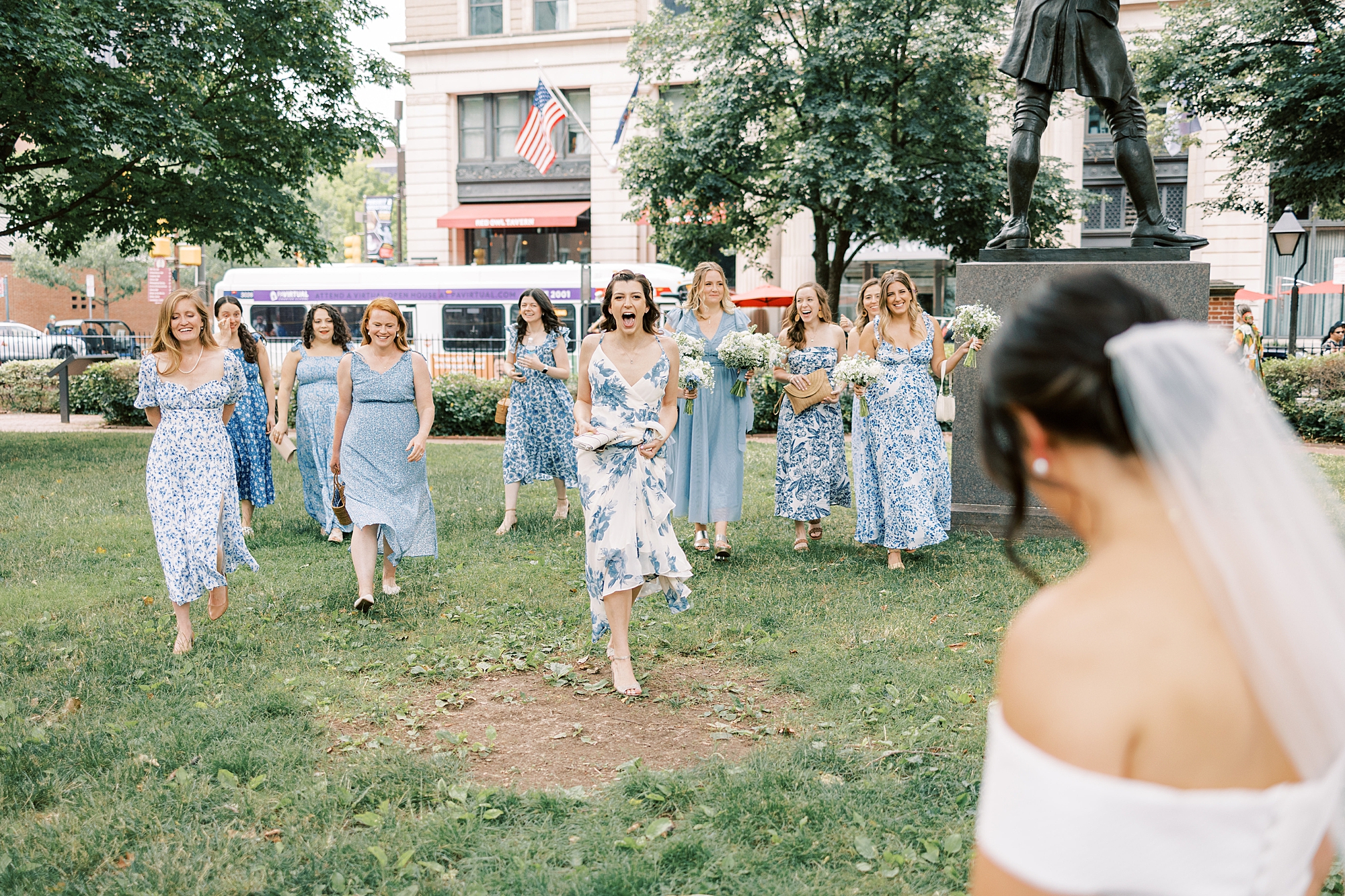 bridesmaids react to seeing bride in wedding dress in Philly park