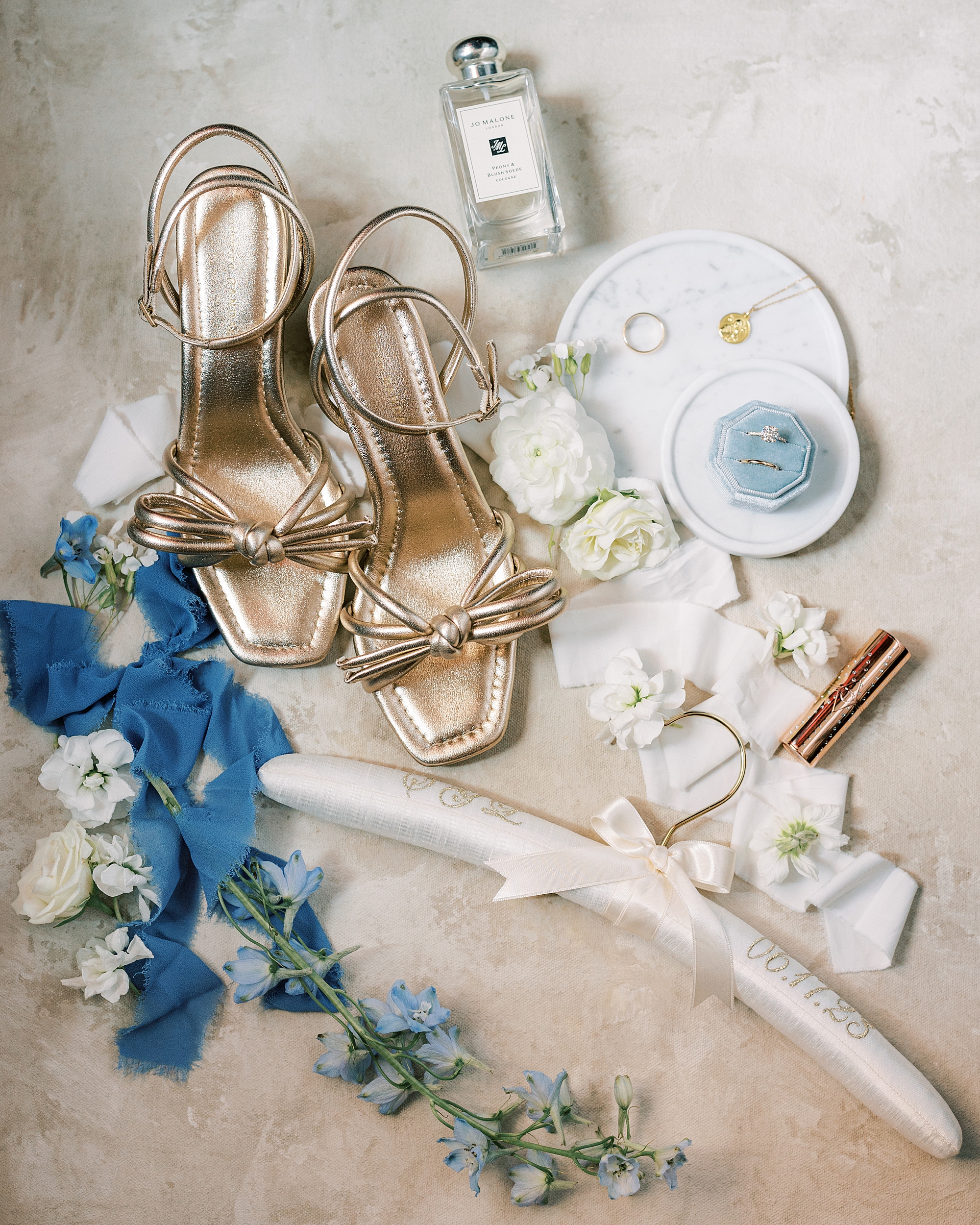 bride's gold shoes, blue jewelry box, and flower accents before Philly wedding