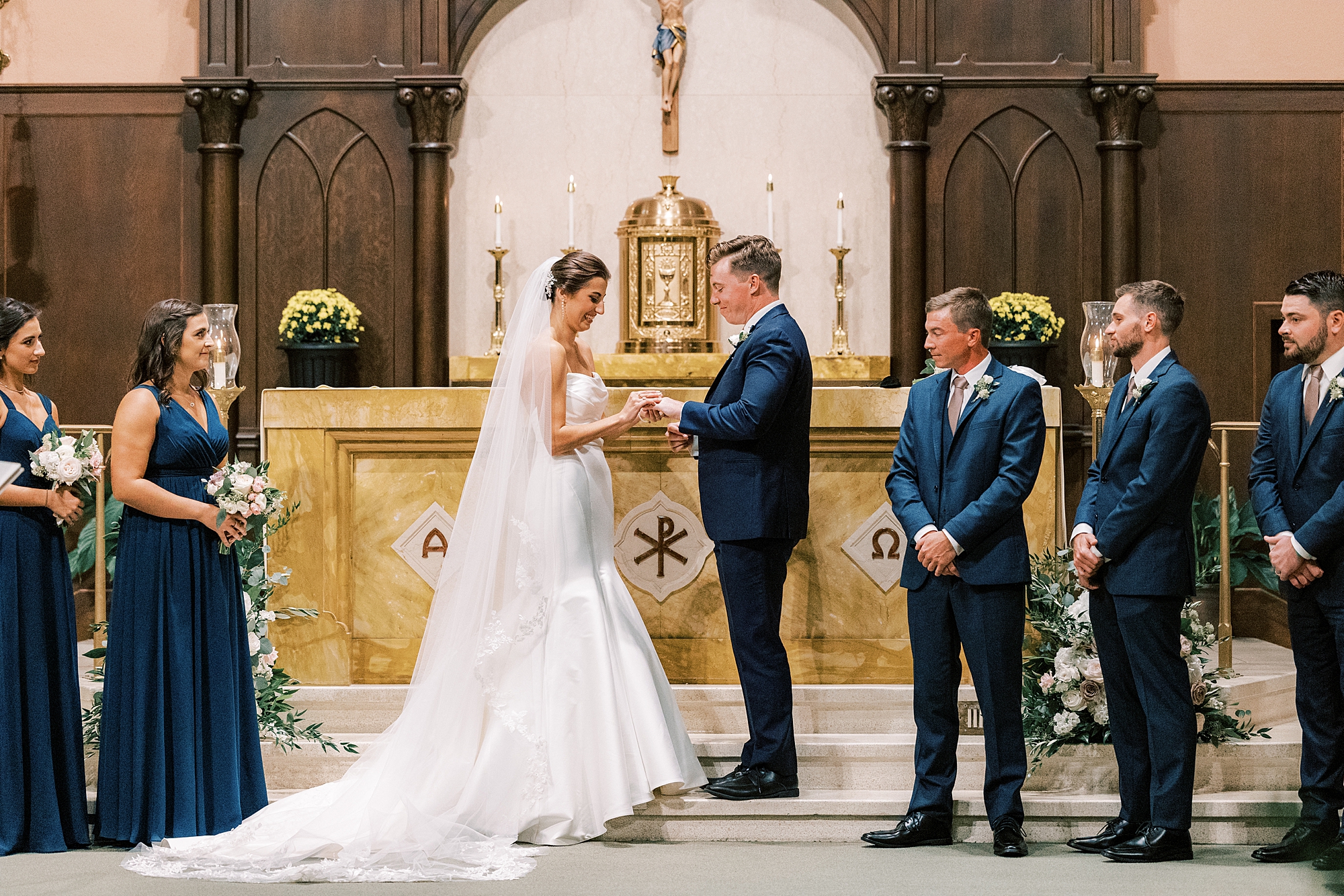 newlyweds hold hands exchanging vows during traditional wedding ceremony at Philadelphia PA church