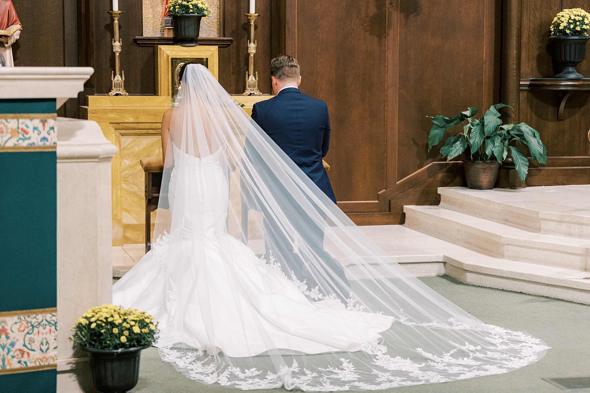 bride and groom pray during traditional wedding ceremony at Philadelphia PA church