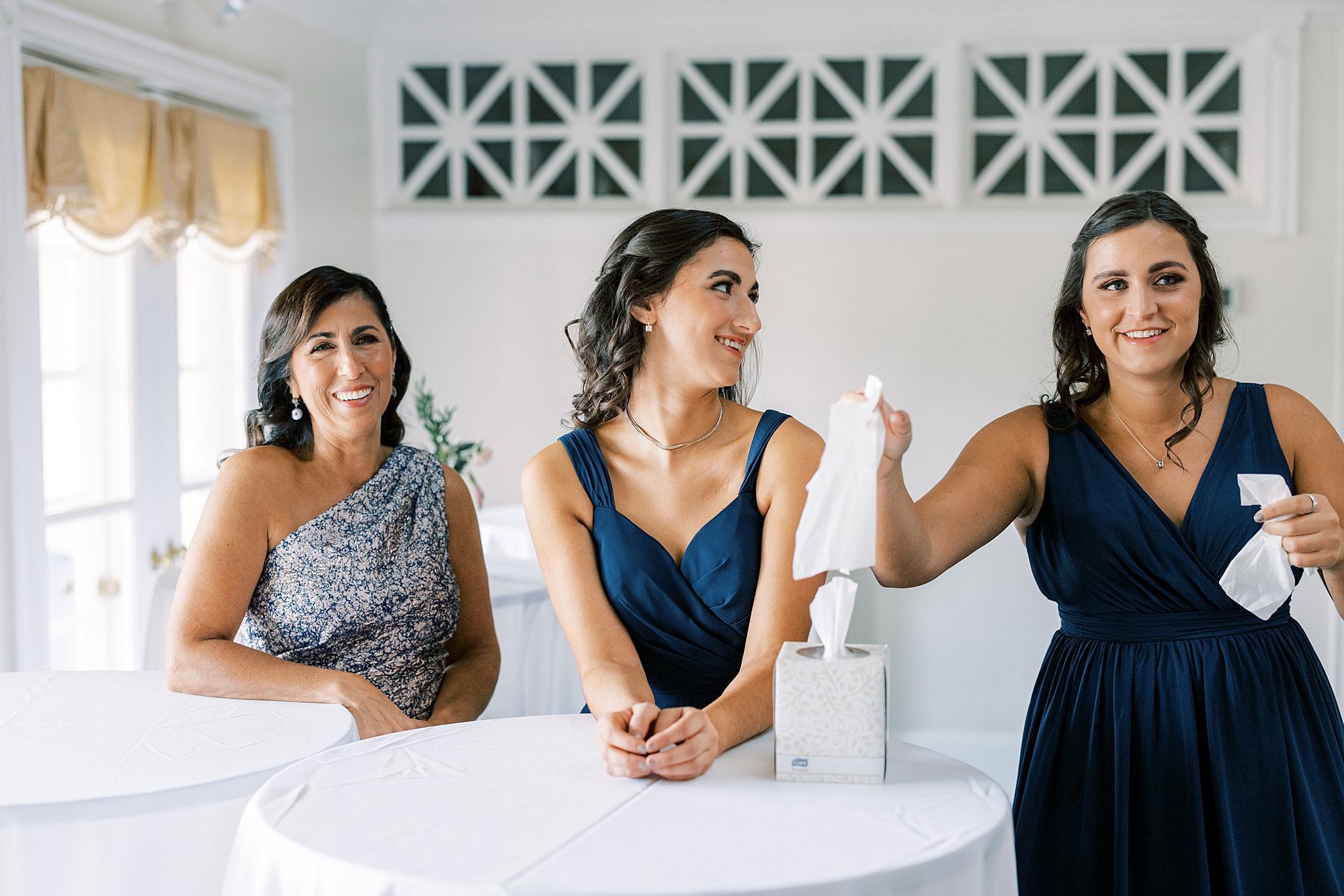 bridesmaid reaches for tissues inside the lobby of the Philadelphia Cricket Club