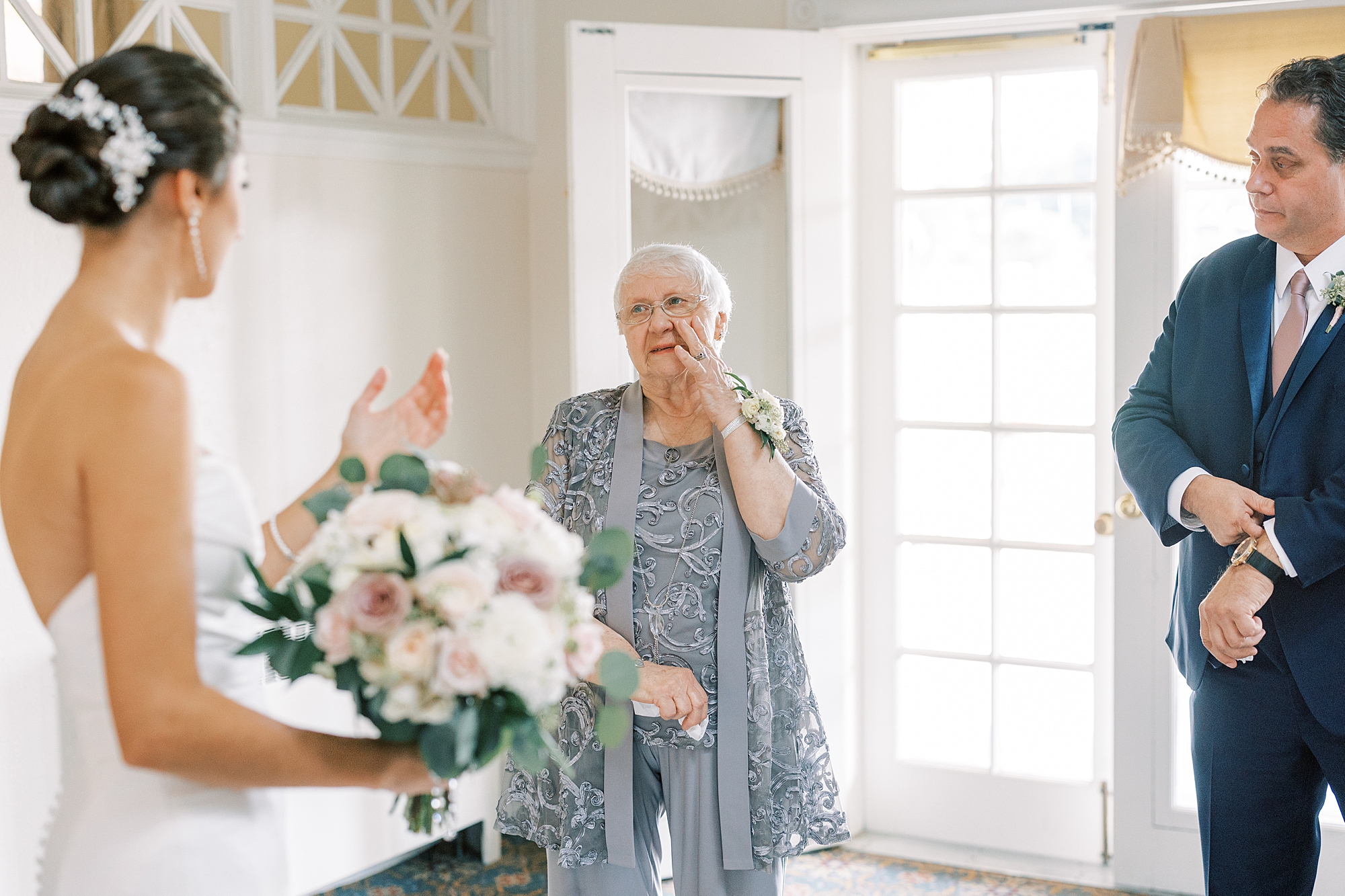 grandmother cries during first look with granddaughter bride 