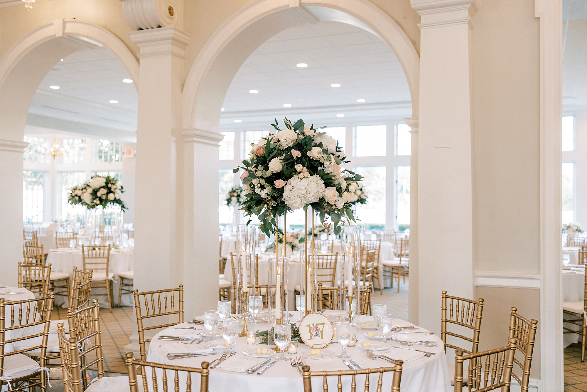 wedding reception with tall floral centerpiece at the Philadelphia Cricket Club