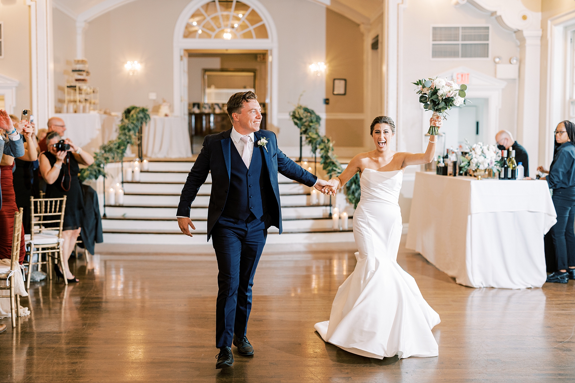 newlyweds cheer walking into wedding reception at the Philadelphia Cricket Club