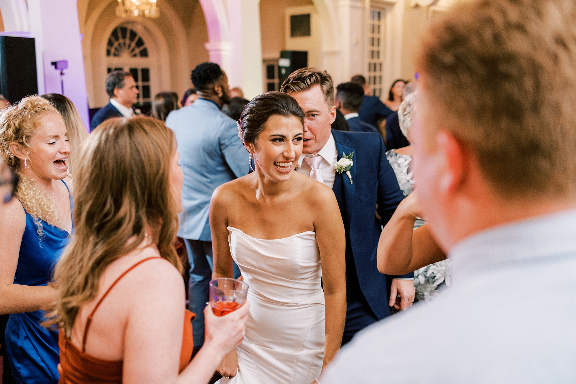 bride smiles at guests during wedding reception in Philadelphia PA