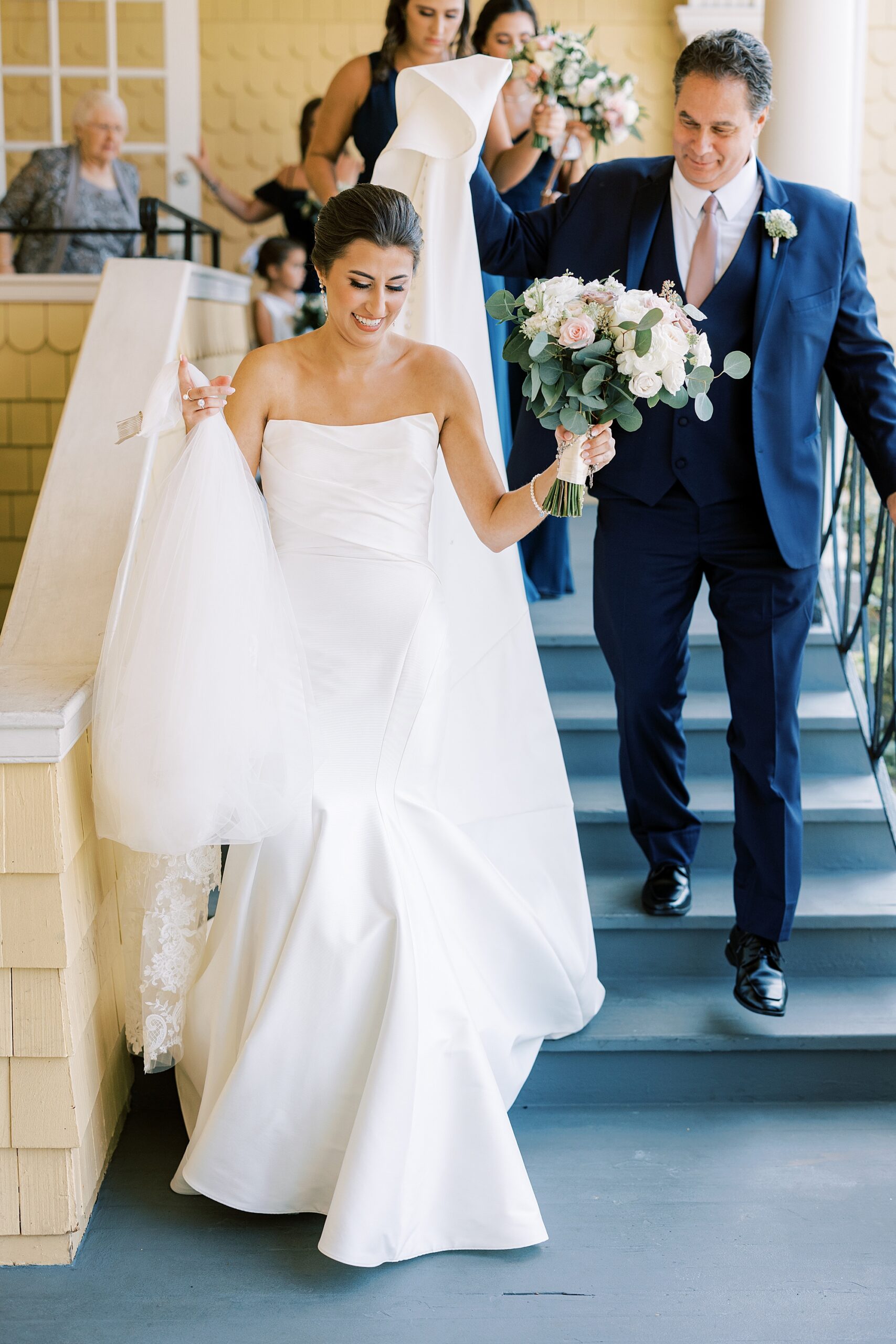 bride and groom walk down steps inside the Philadelphia Cricket Club