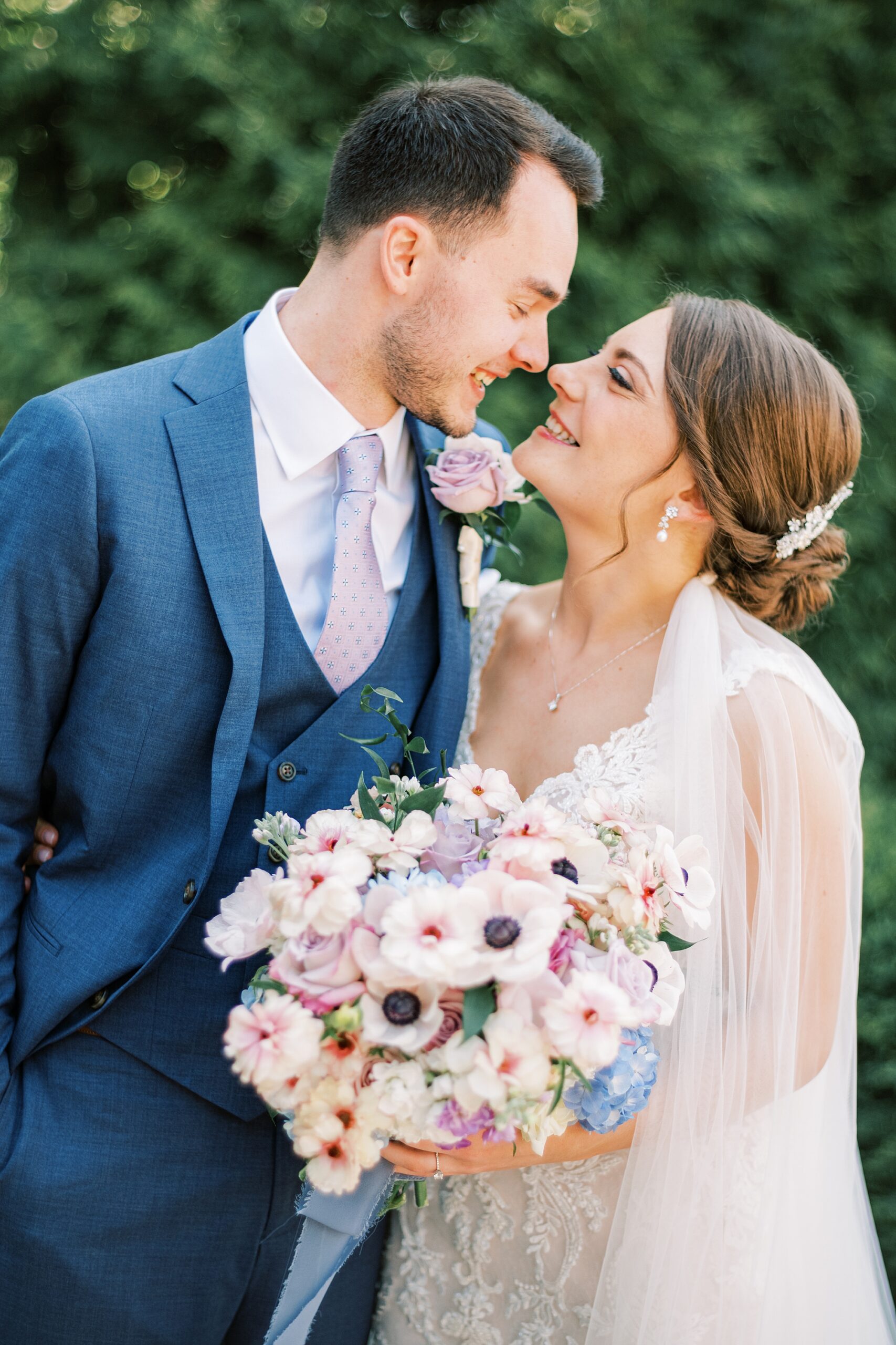 bride and groom lean together touching noses during portraits at Lake House Inn