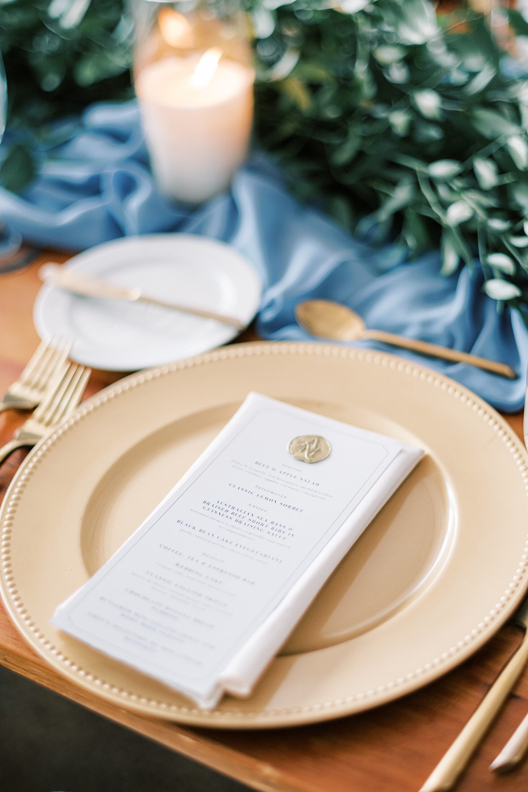 menu card lays on gold plate with gold wax seal 