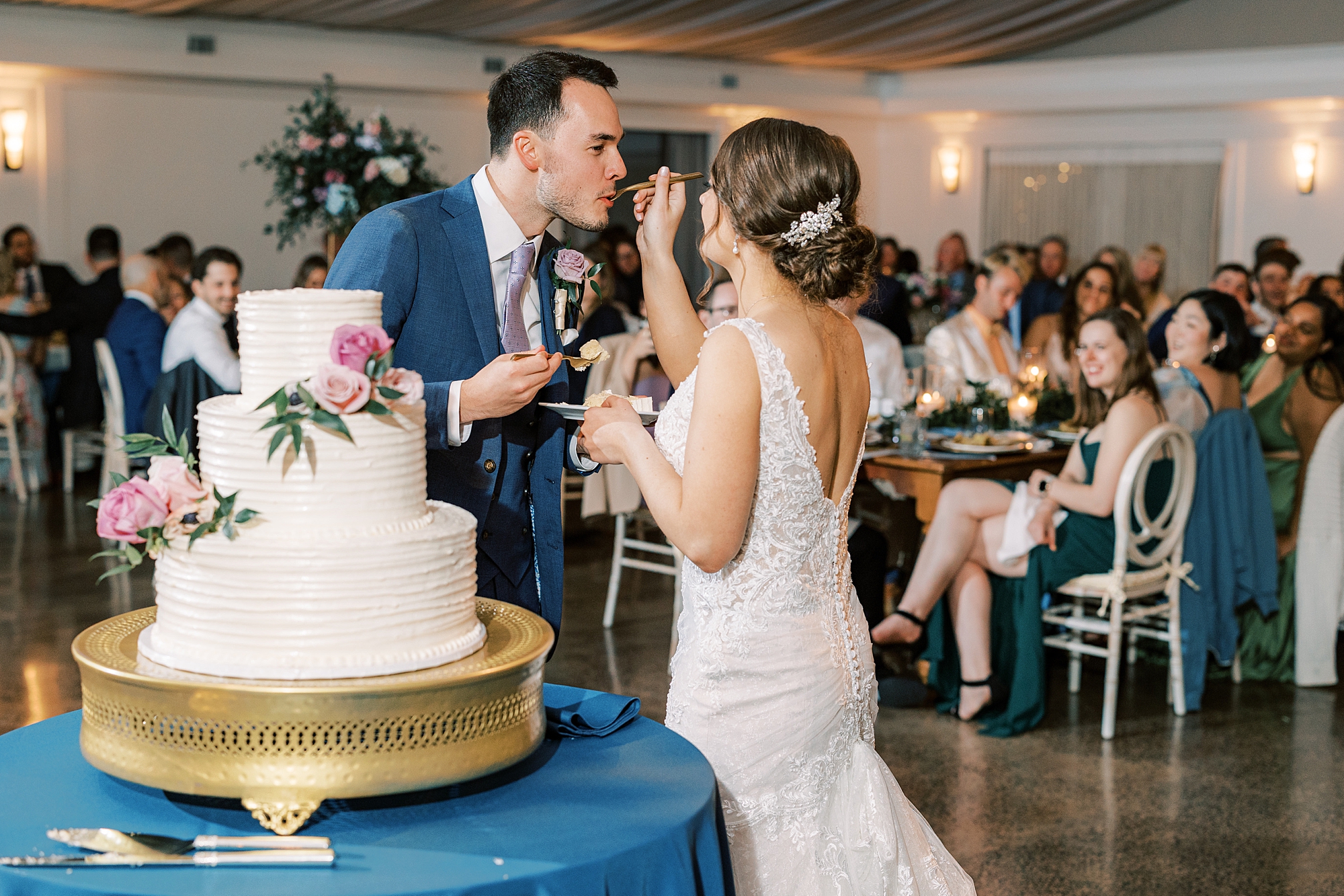 bride and groom feed each other cake during Perkasie PA wedding reception 