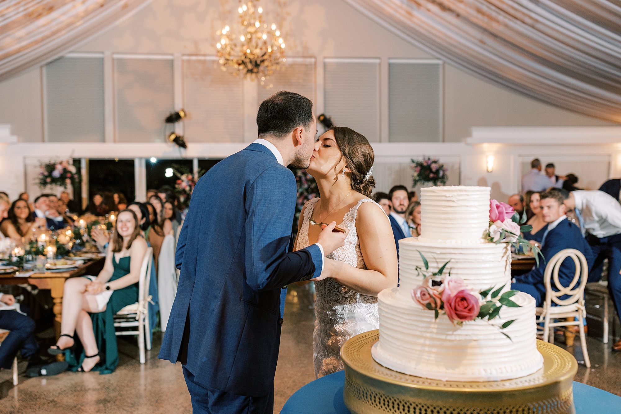 bride and groom kiss after cake cutting during Perkasie PA wedding reception 