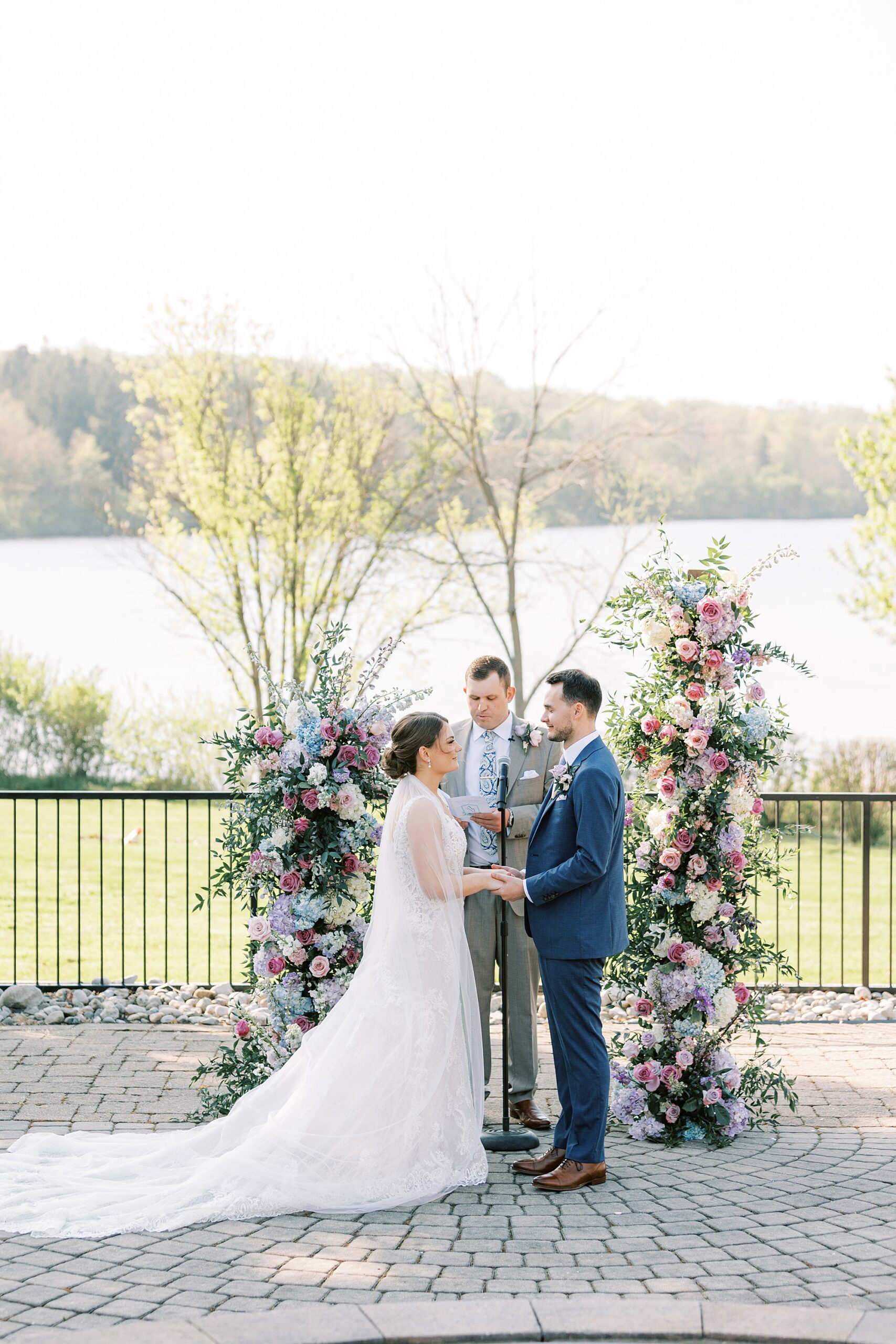 ceremony in the gardens at Lake House Inn with pink and purple flower installation