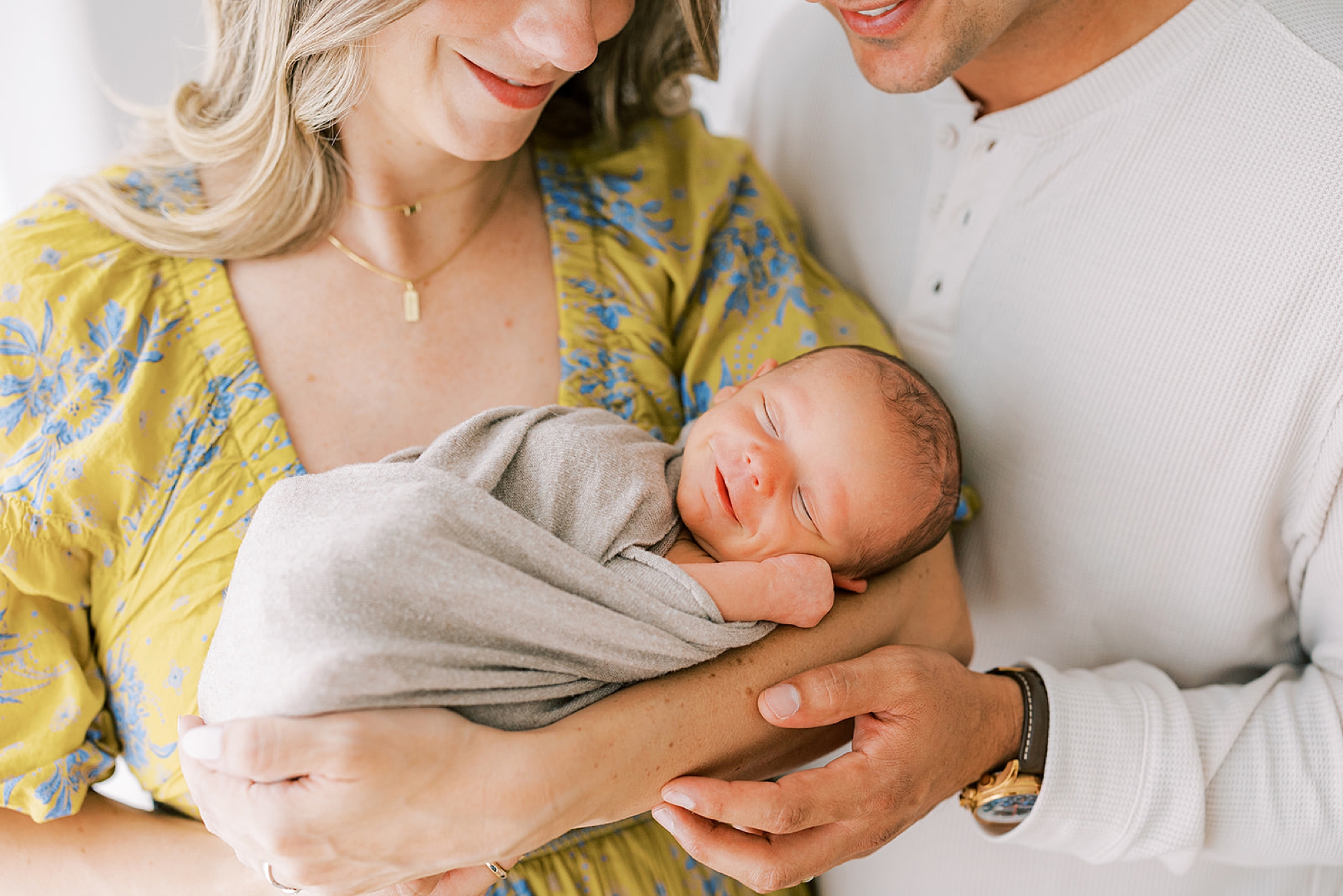 parents hug son snuggling during studio newborn photos in Media PA