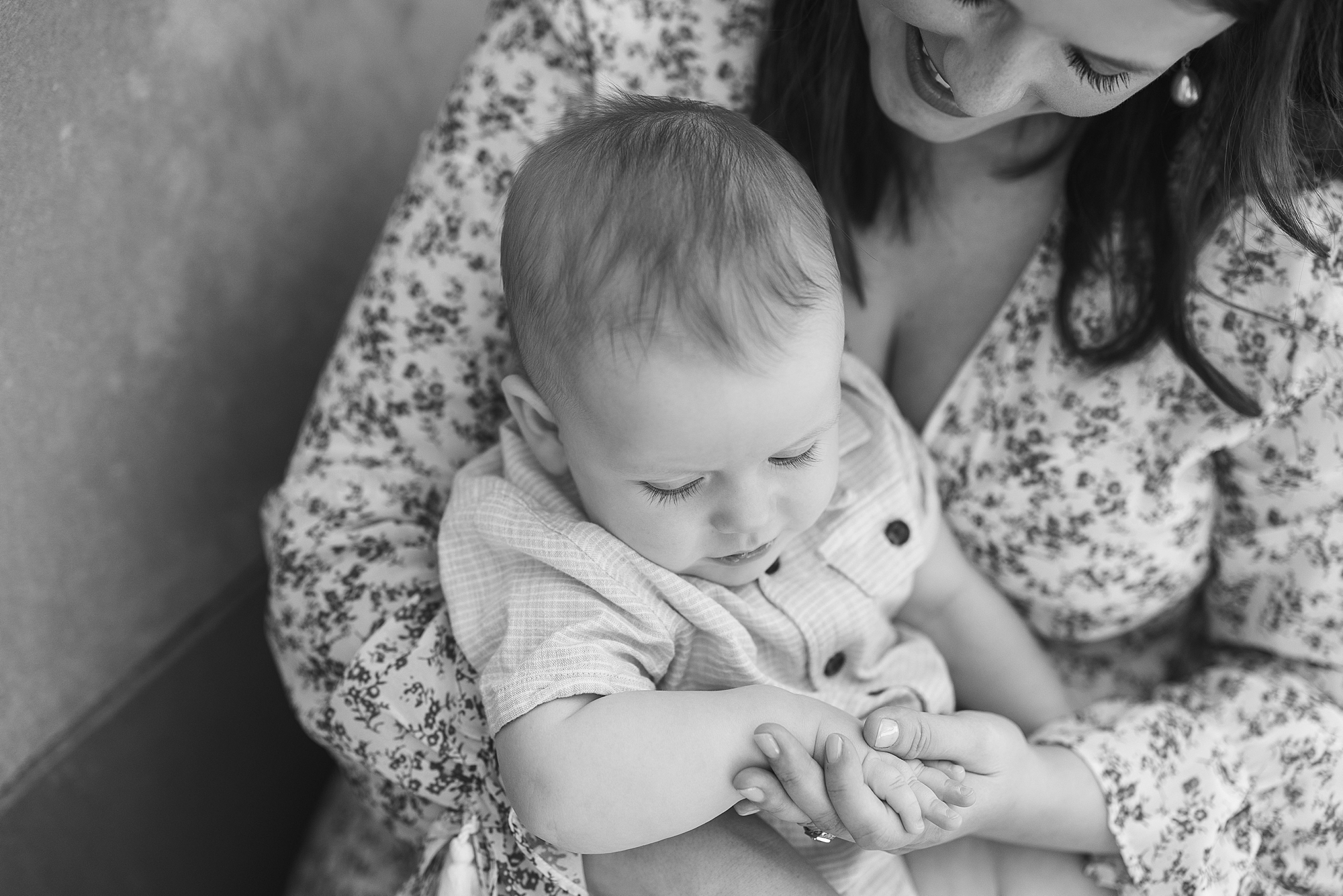 mom holds son in lap smiling down at him during Pennsylvania family photos