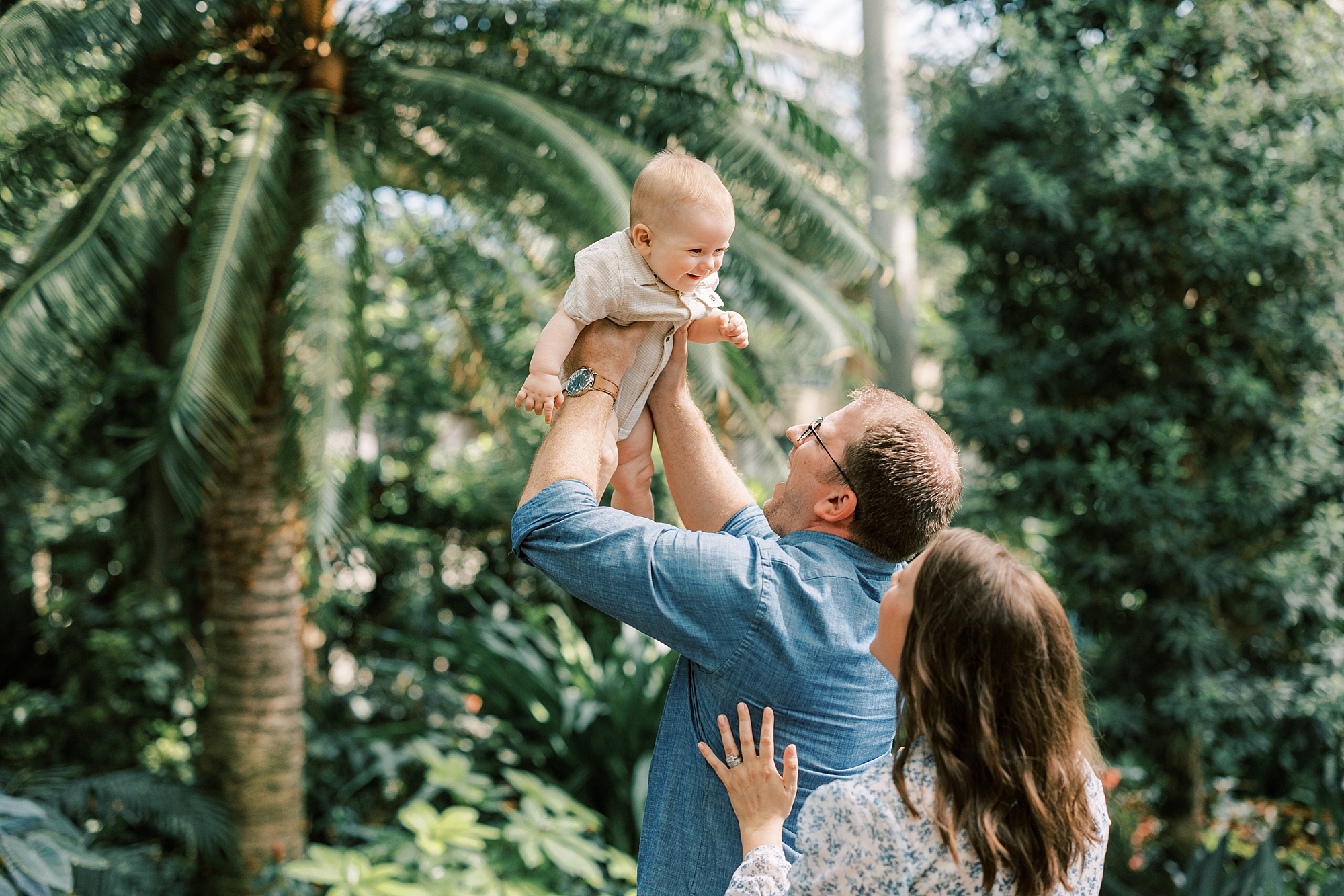 dad lifts up son in the air making him laugh during PA family photos 