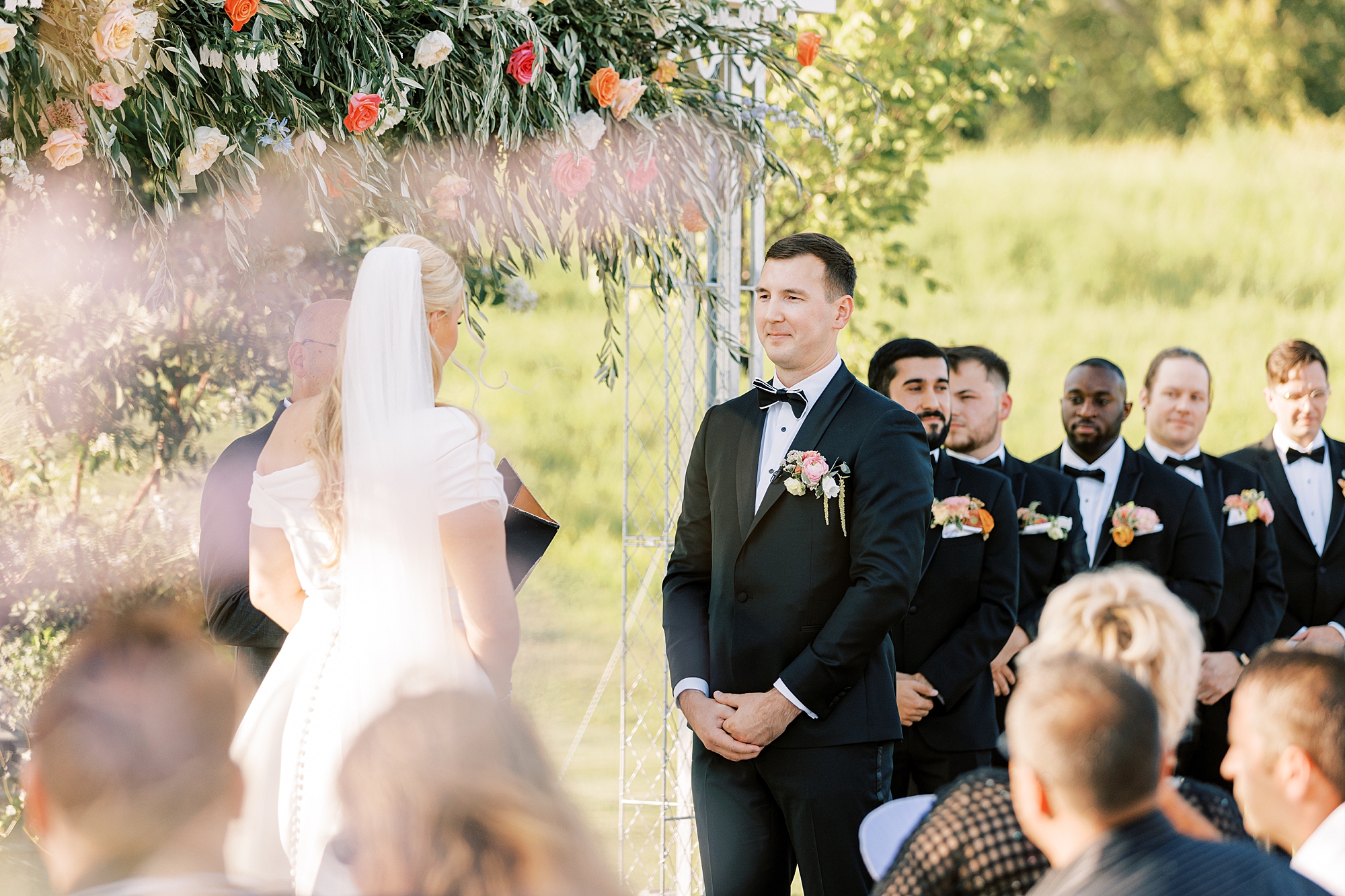 groom looks at bride during wedding ceremony 