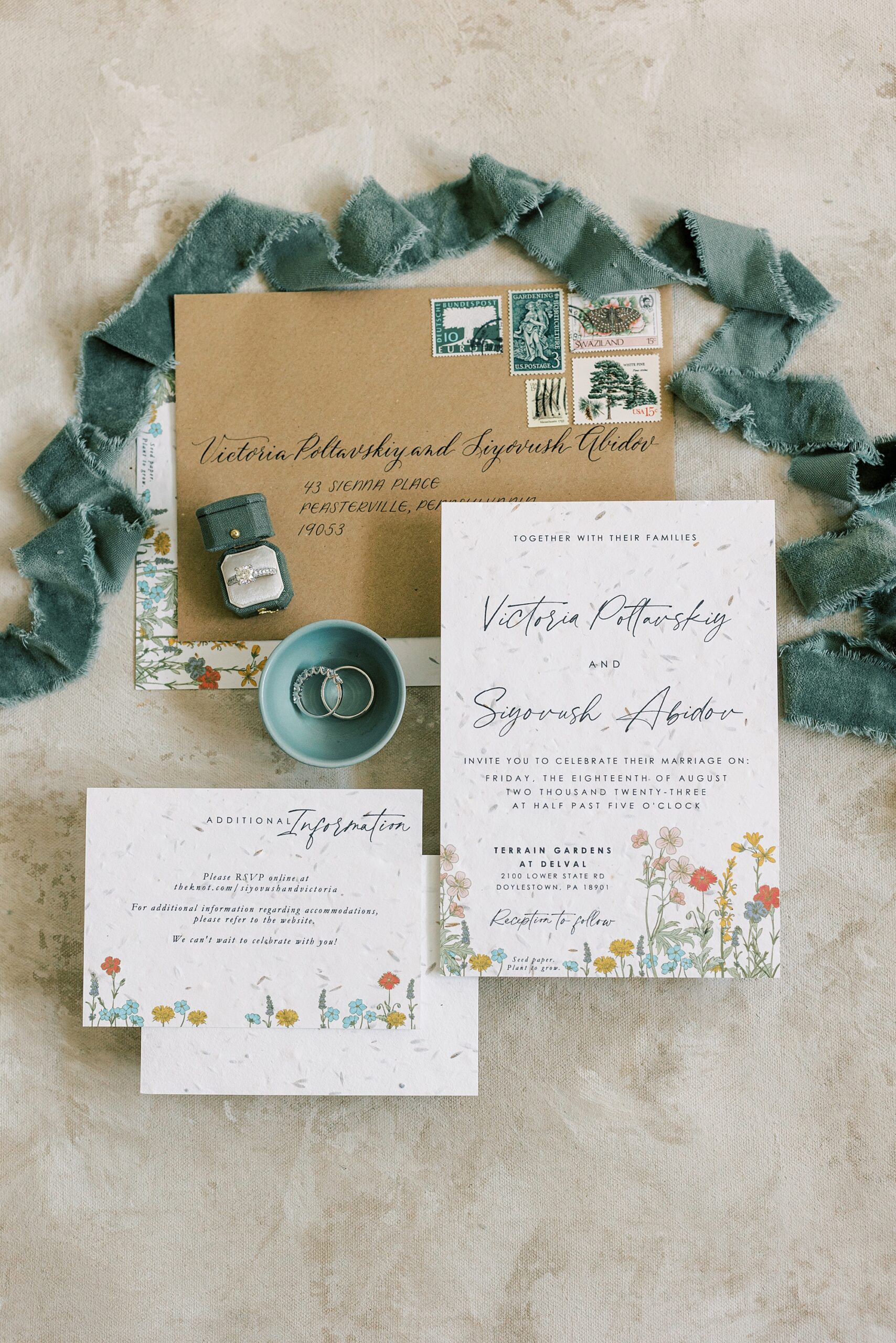 invitation suite with wildflower accents and blue ribbon around top