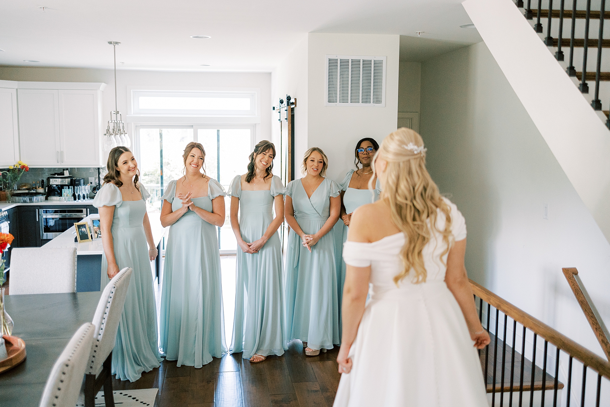 bridesmaids in blue dress have first look with bride in house at Terrain DelVal