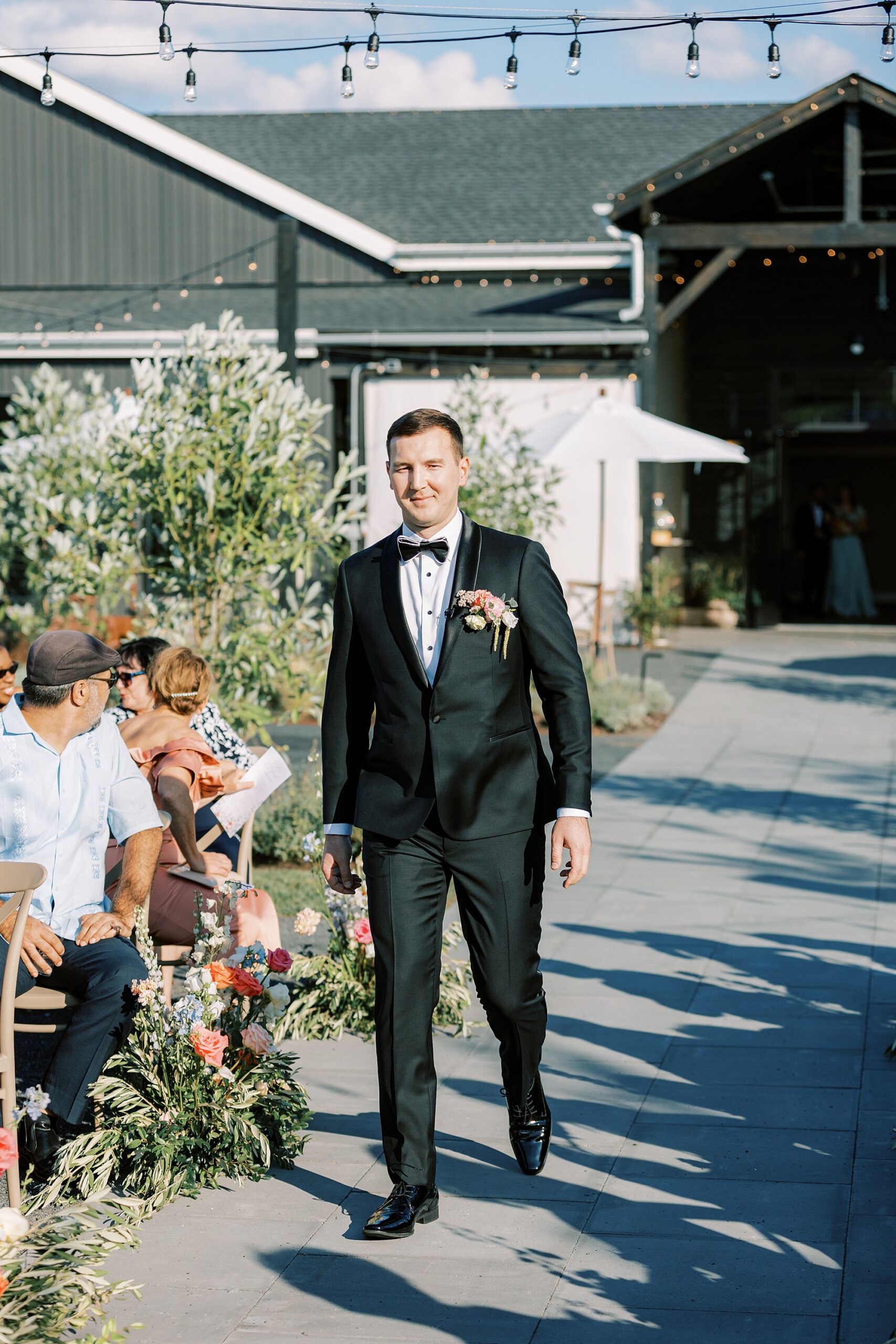 groom walks down aisle at Terrain DelVal for wedding ceremony 