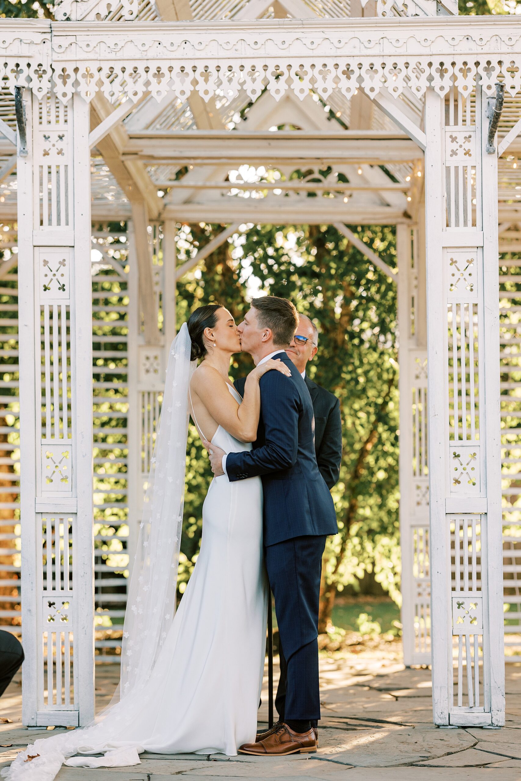 bride and groom kiss under gazebo at the Terrain at Styer's in Glen Mills PA