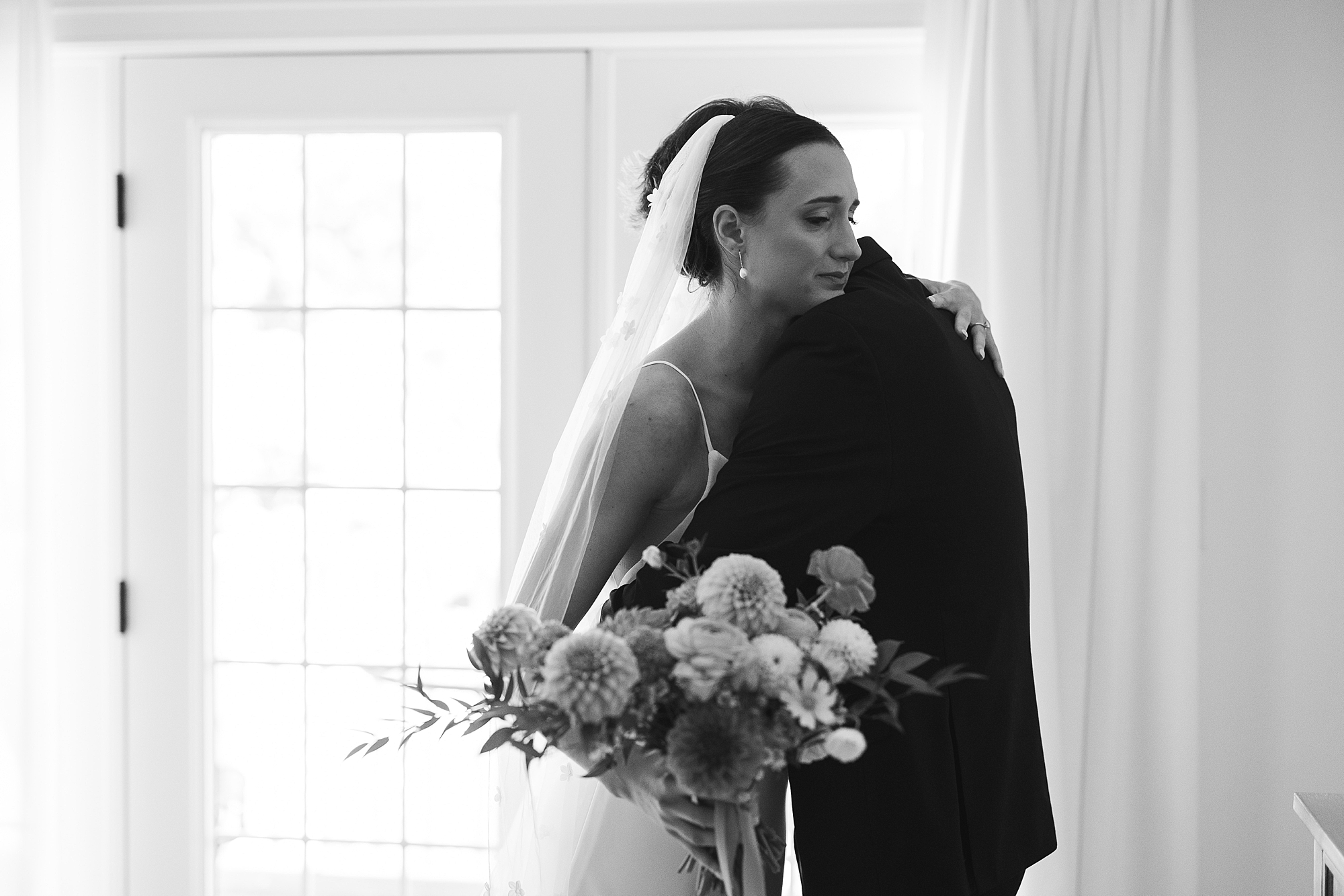 bride hugs brother during first look at Fairville Inn