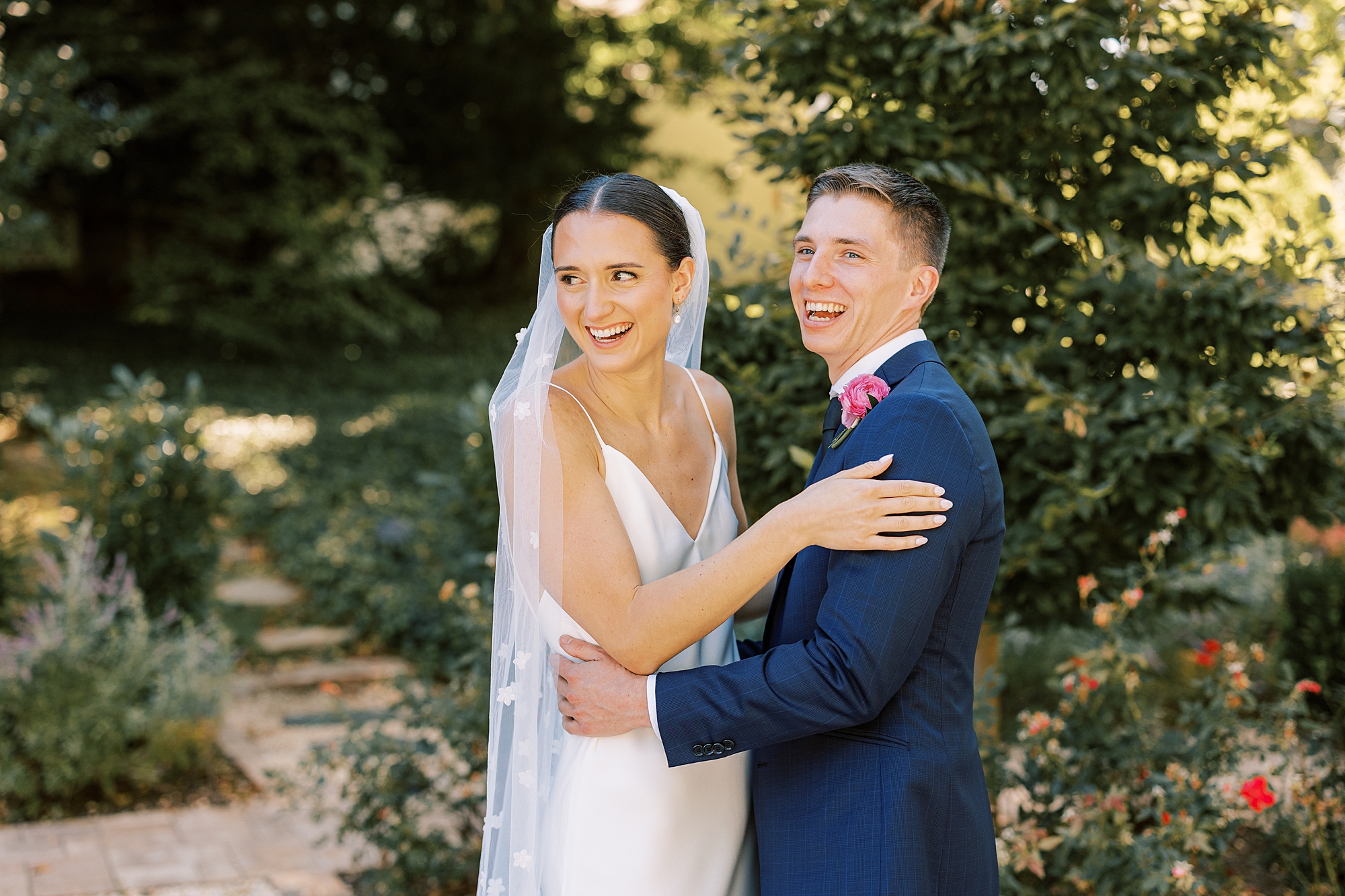 newlyweds smile and laugh at guests during Fairville Inn in Chadds Ford