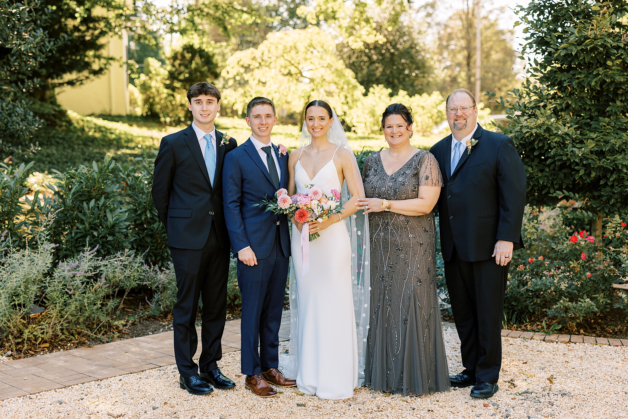 family poses with bride at Fairville Inn in Chadds Ford