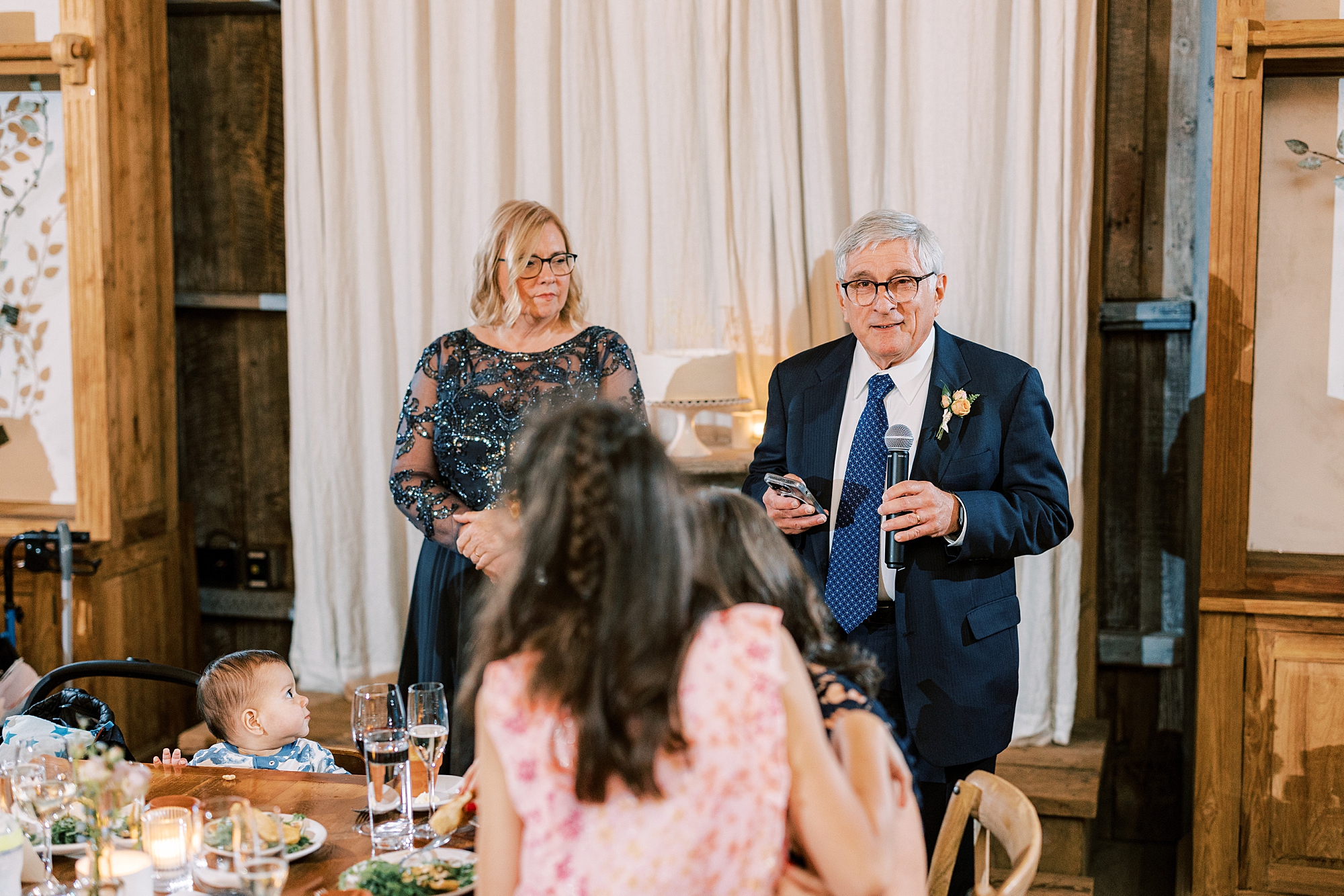 parents give speech during fall wedding celebration at the Terrain at Styer's