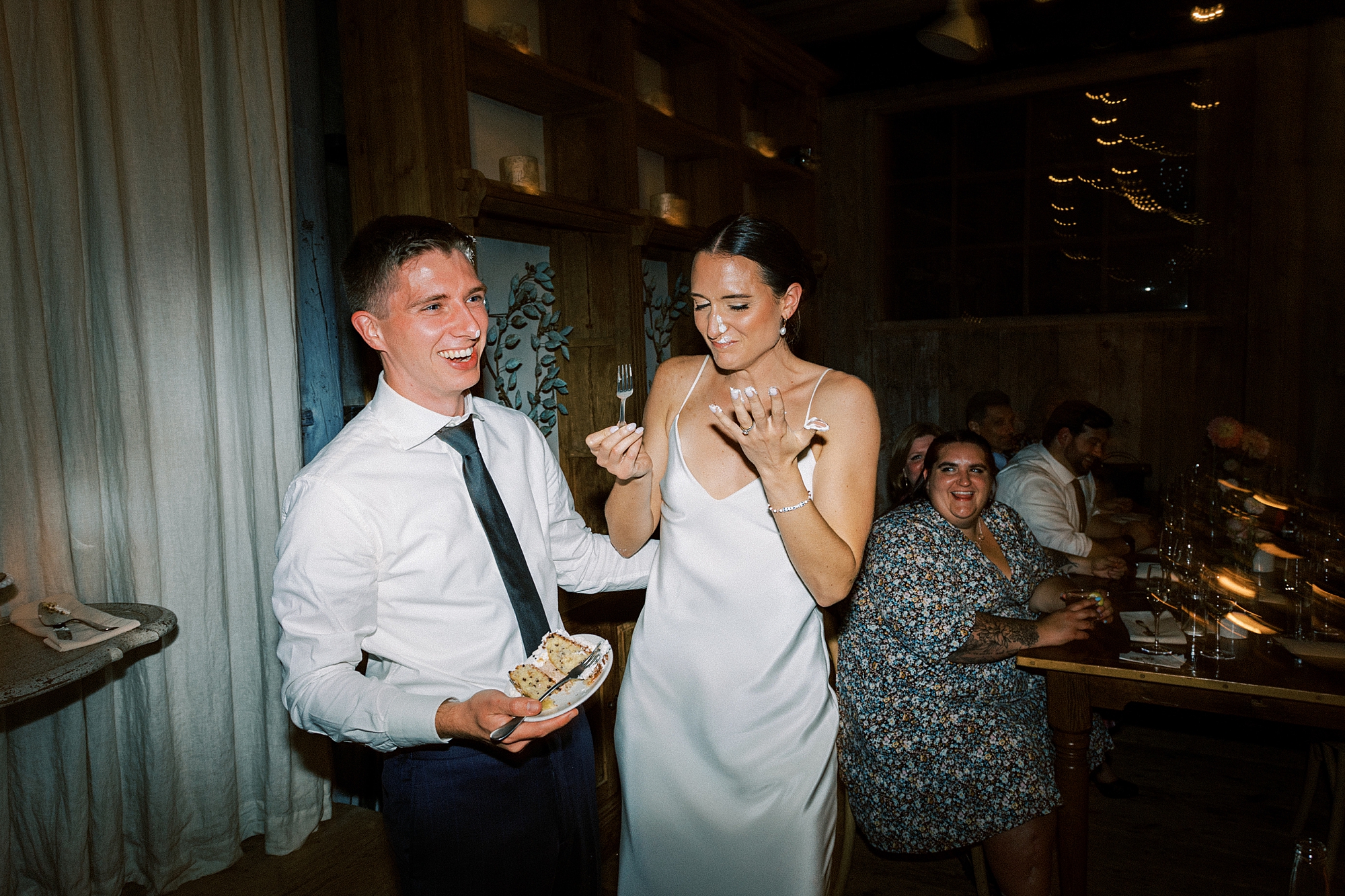 newlyweds feed each other cake during PA wedding reception