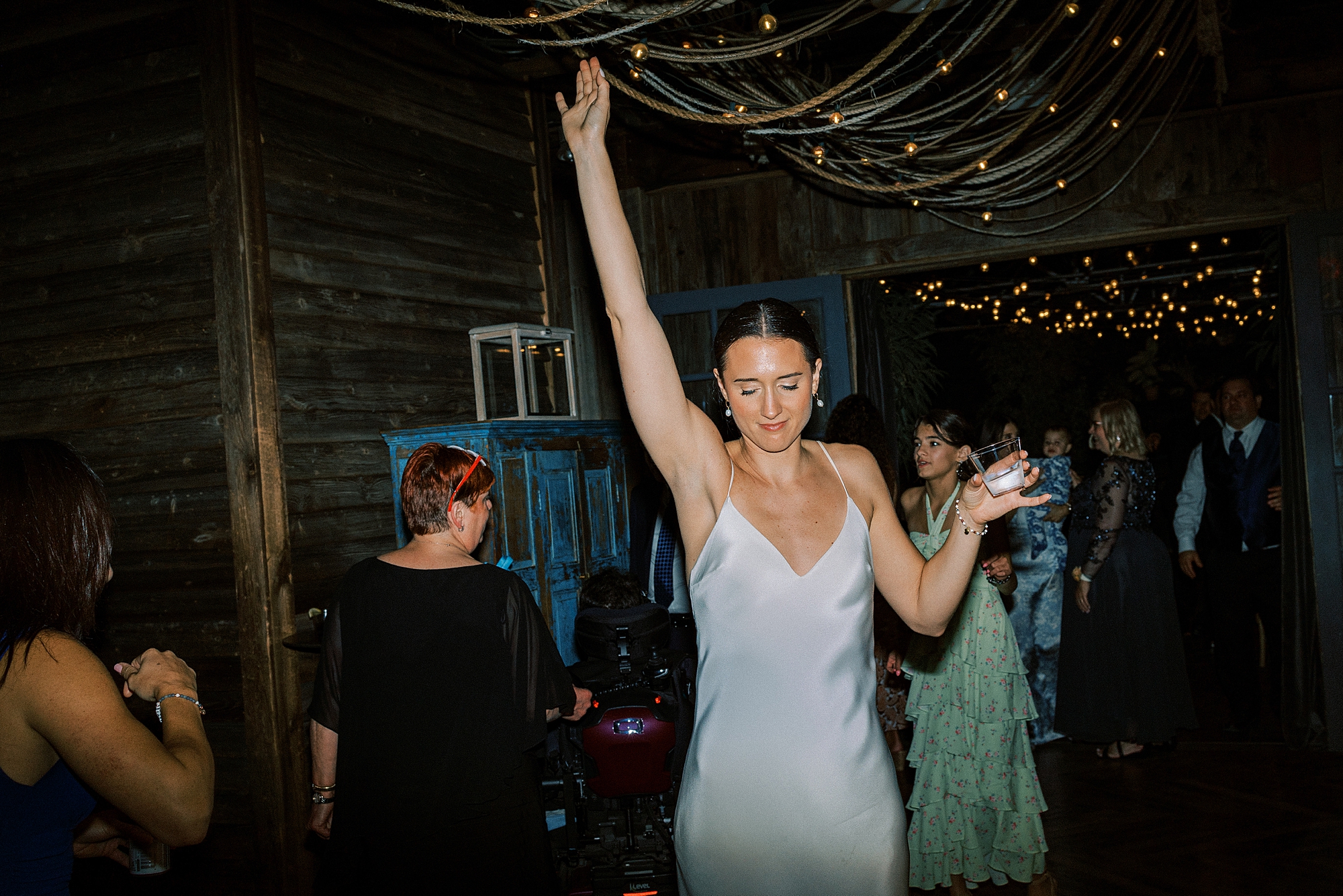 bride dances under bistro lights at PA wedding reception