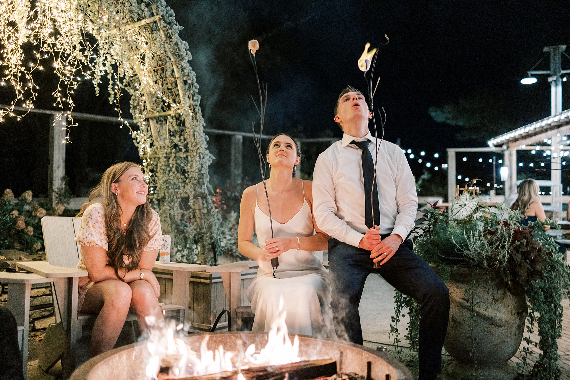 bride and groom rest by fire-it at the Terrain at Styer's in Glen Mills PA