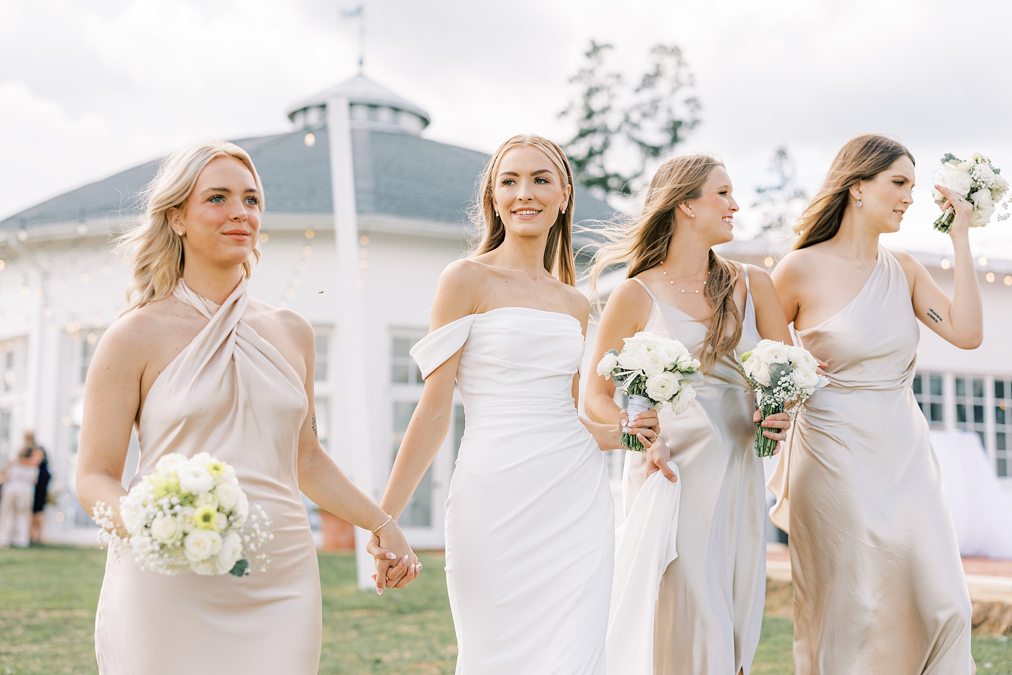 bride in strapless wedding gown walks with bridesmaids at Lauxmont Farms